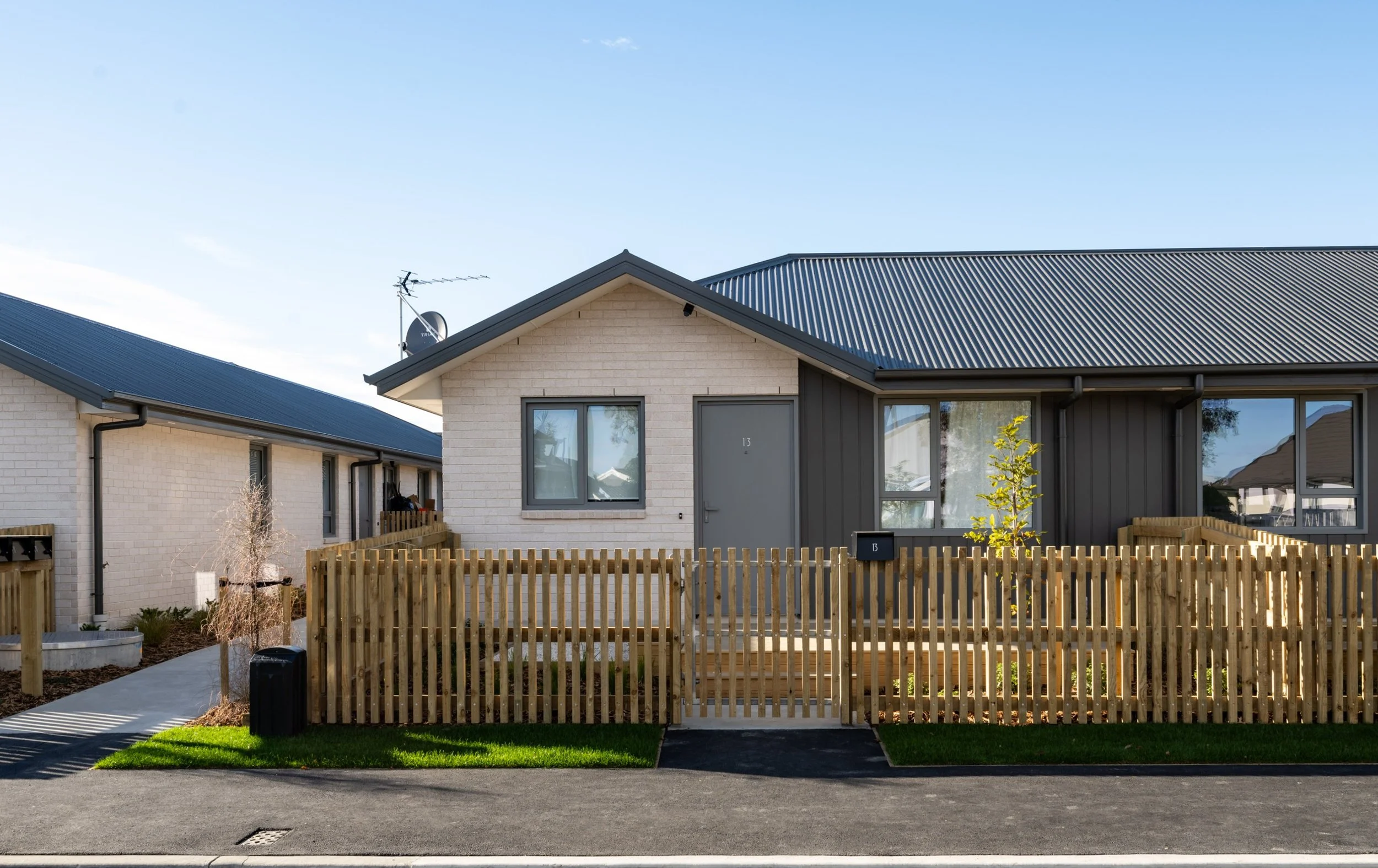Single-level dwellings with street frontage, fencing and garden areas.
