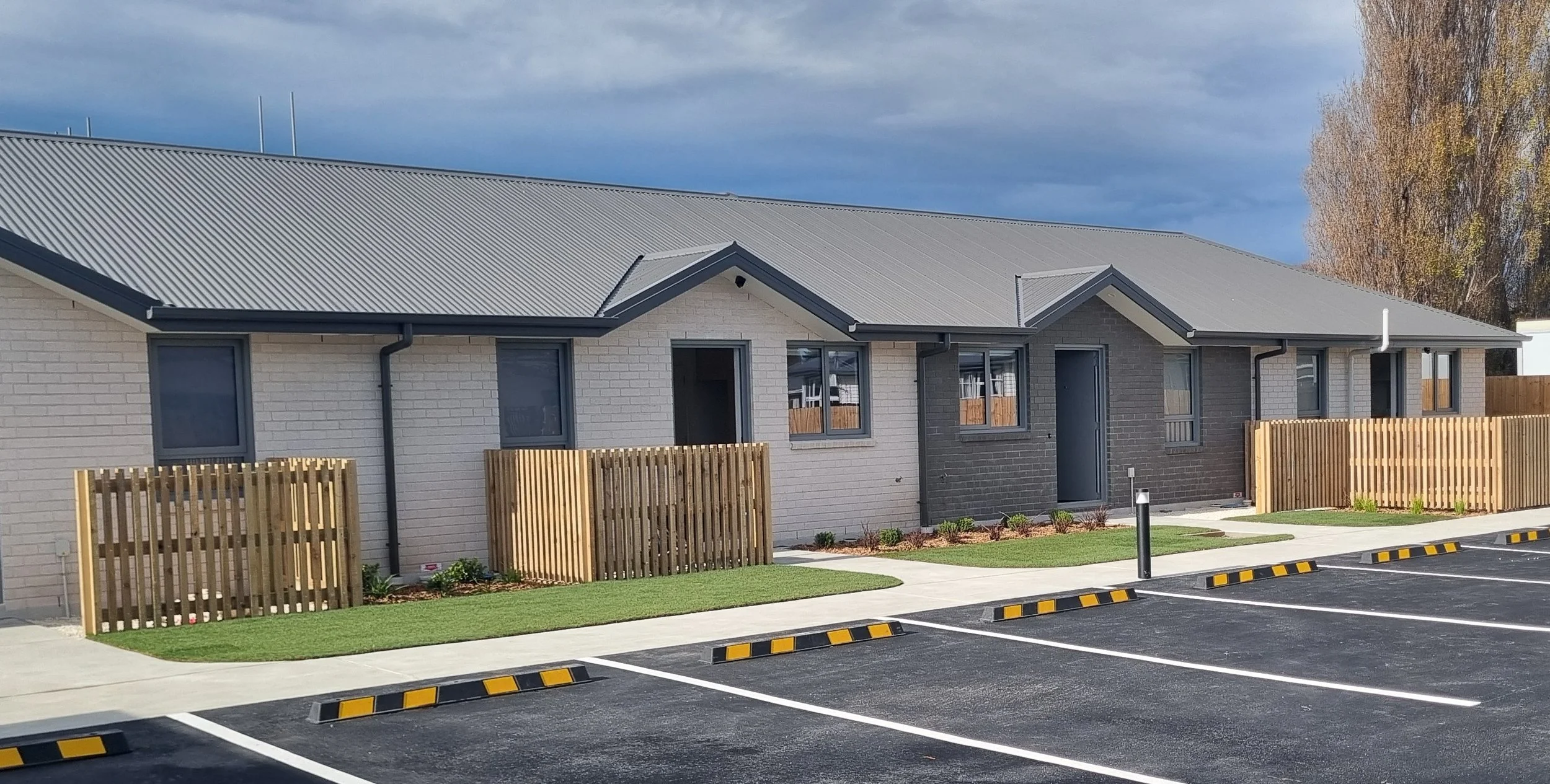 Exterior view with planting and carpark spaces