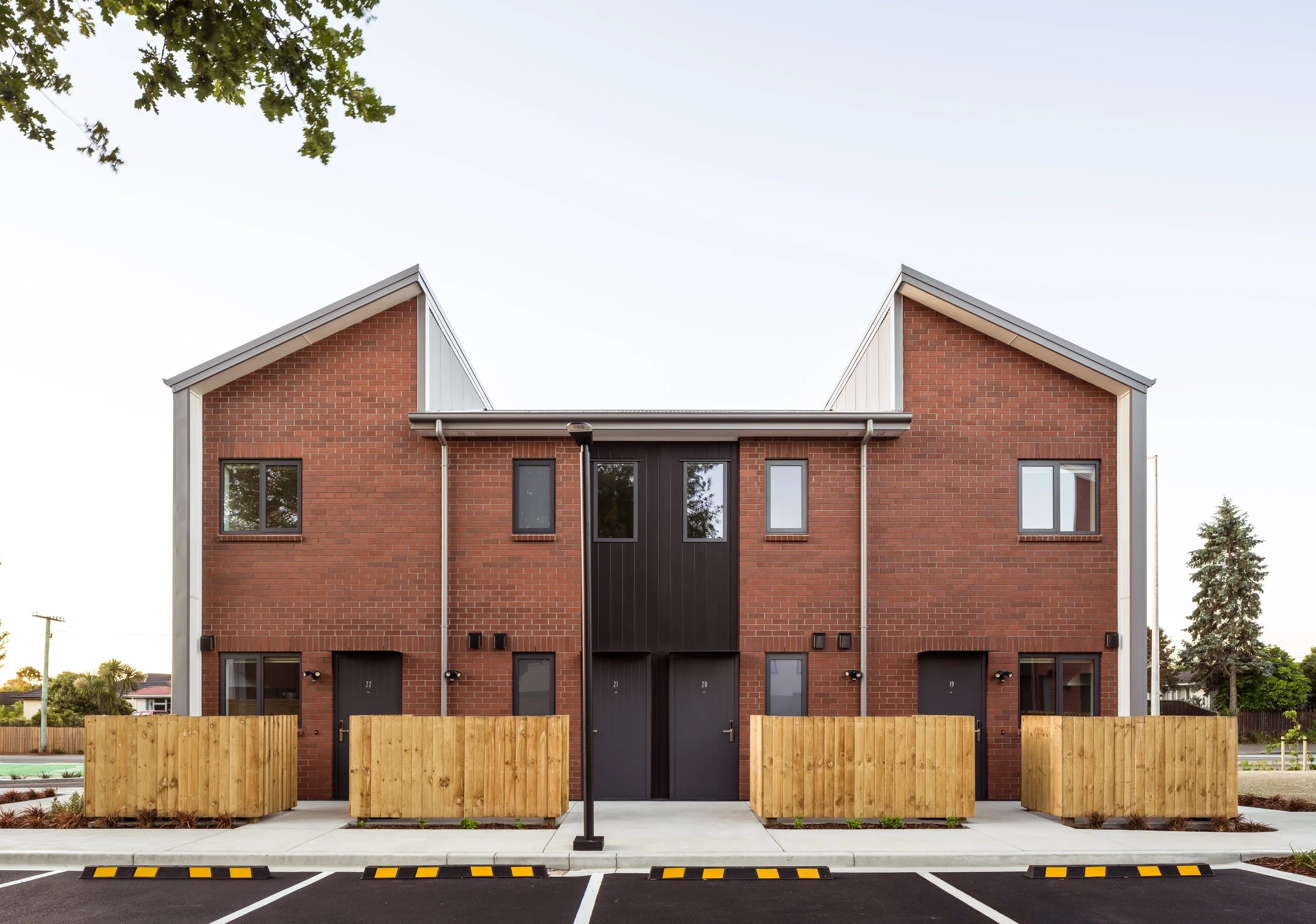 Street level view of one four-dwelling, stand-alone blocks in Three Lanes housing development