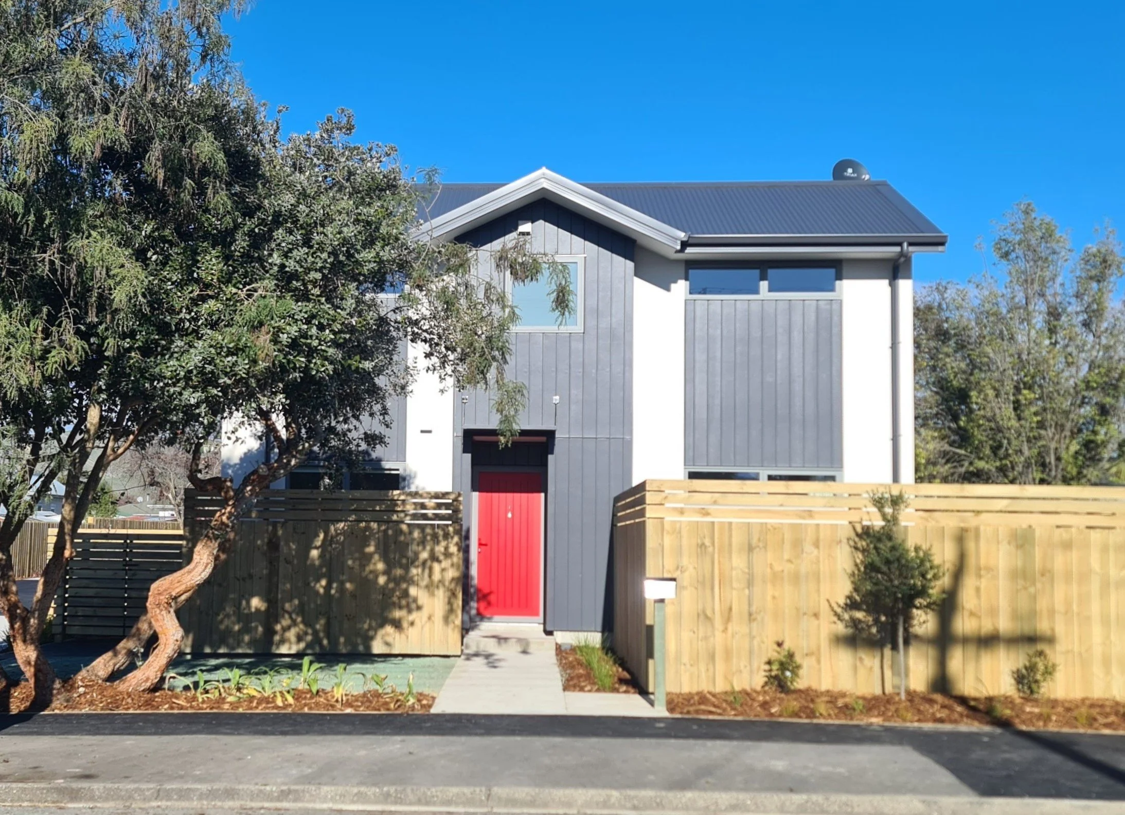 Two-story dwelling with street frontage access and established trees