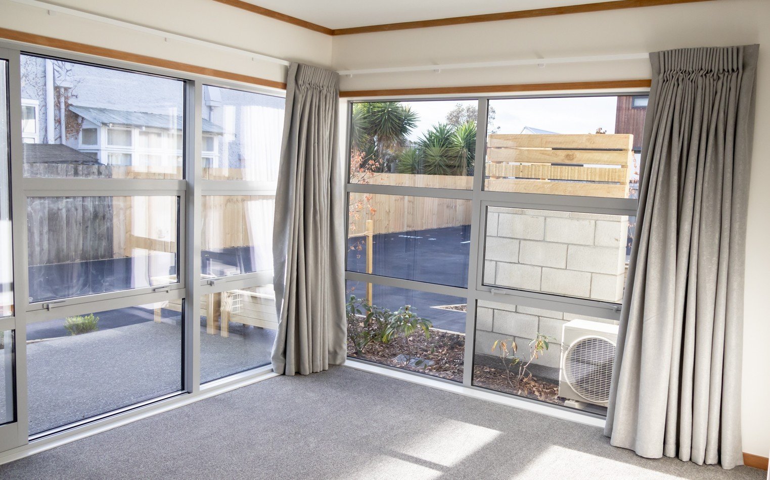 Larger corner windows provide light-filled living areas inside