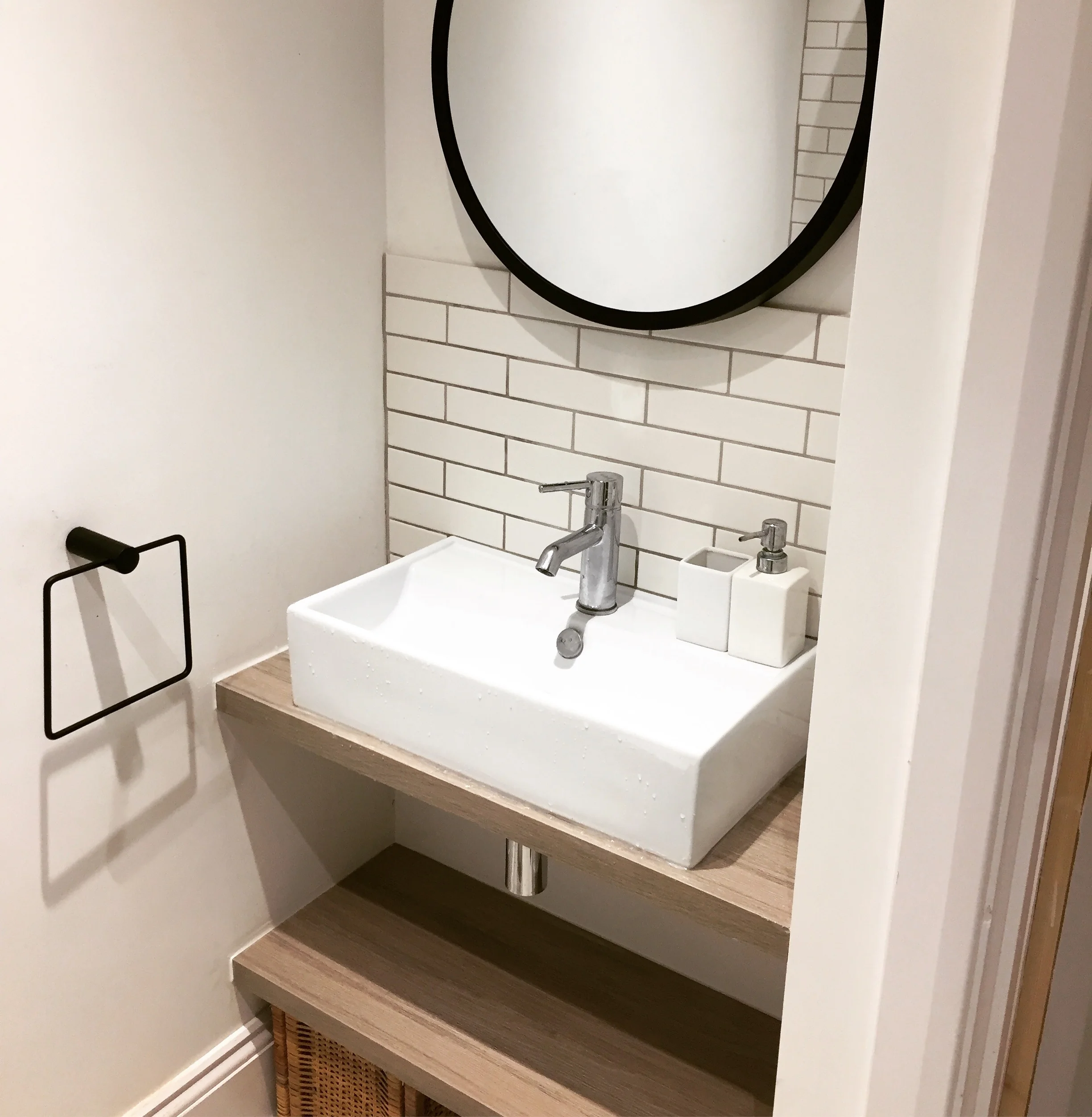   The bathroom sink alcove   The leftover laminate worktop from the kitchen fitted perfectly to make 2 shelves under the sink for extra storage. 