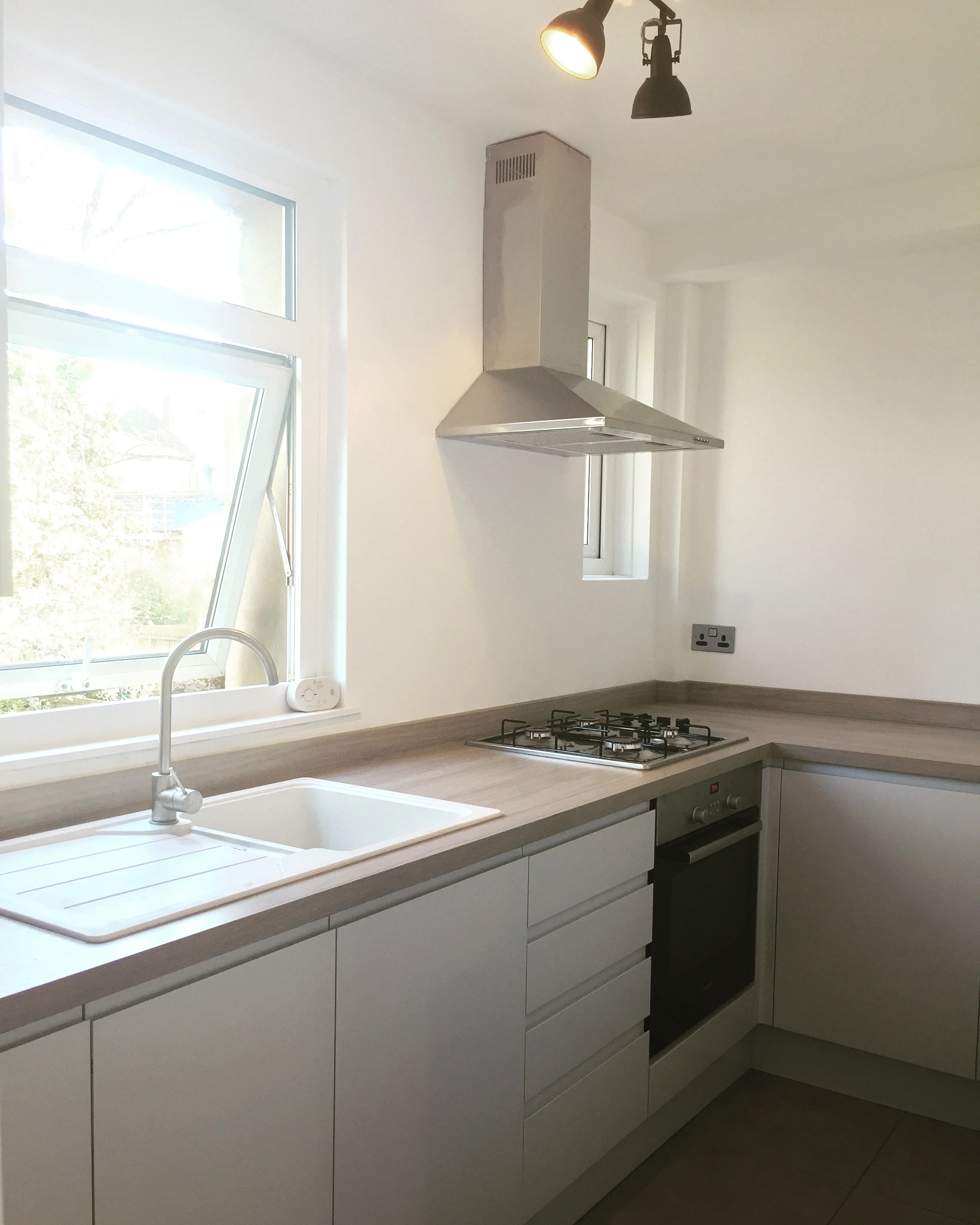   The kitchen   A mixture of warm and cool greys, and industrial light fittings to allow subtle inkeeping with the design of the rest of the space. 
