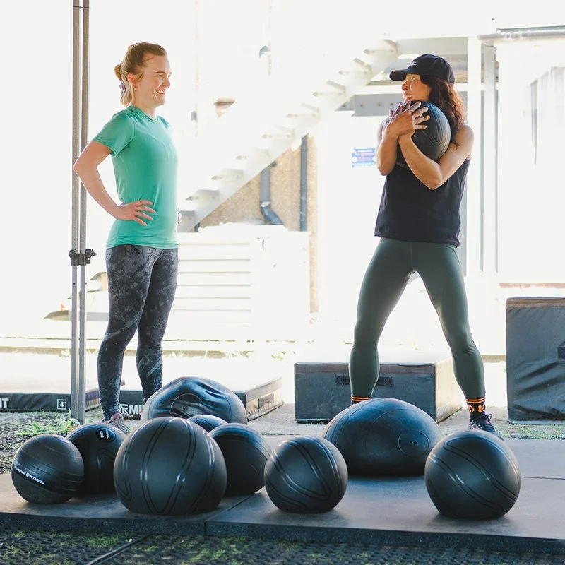 Female Yoked Fitness member talking to a female coach