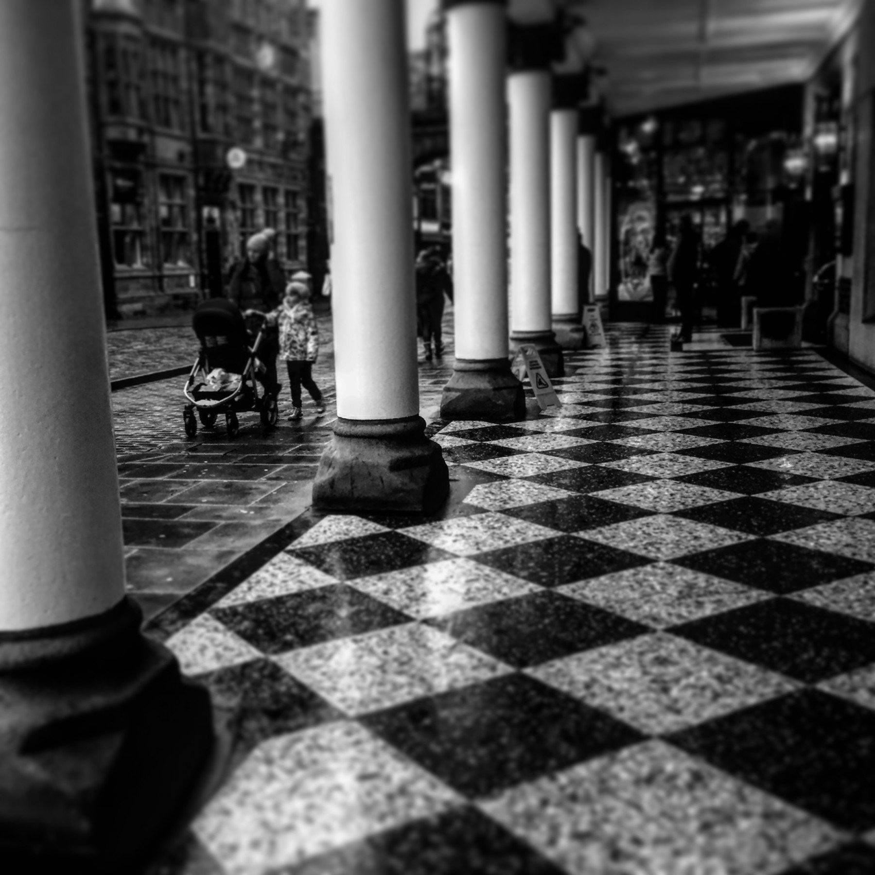 Black and white tiled floor with pillars leading up to Grosvenor Hotel