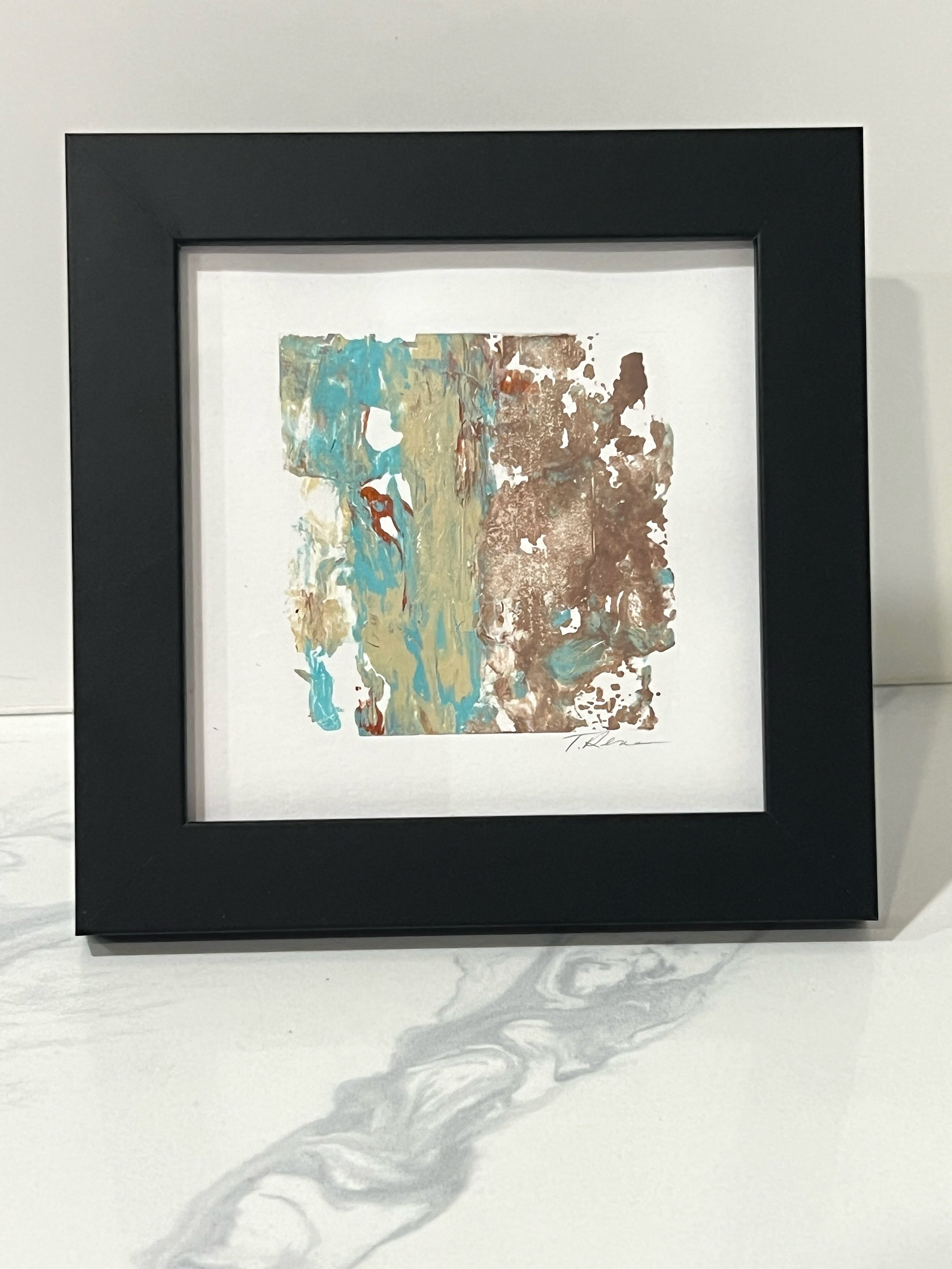 Framed miniature by Tanja Rene rests on tabletop