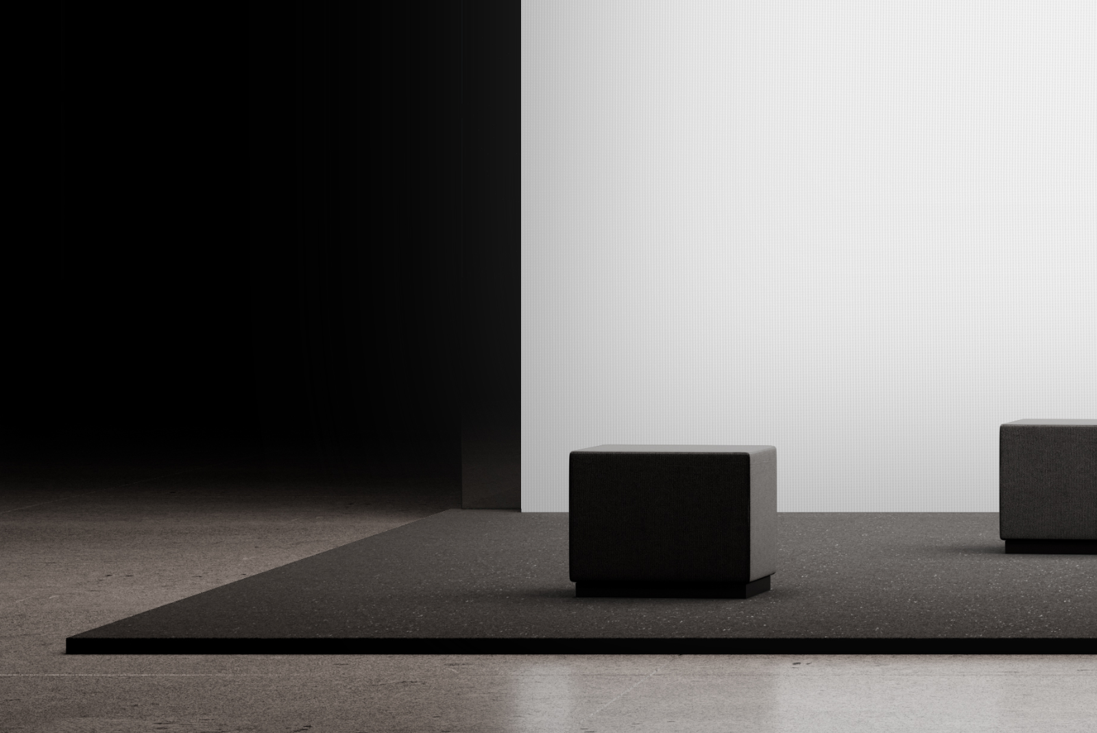 Close-up of upholstered seating cube on a minimalist exhibition stand