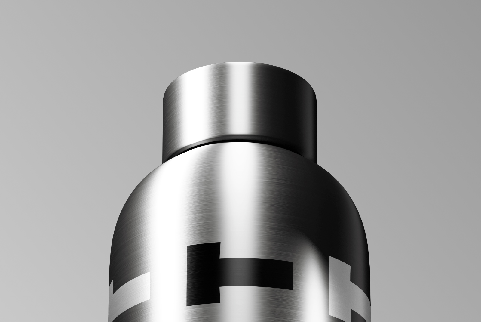 Close-up of metallic bottle cap with vertical text design and brushed steel texture