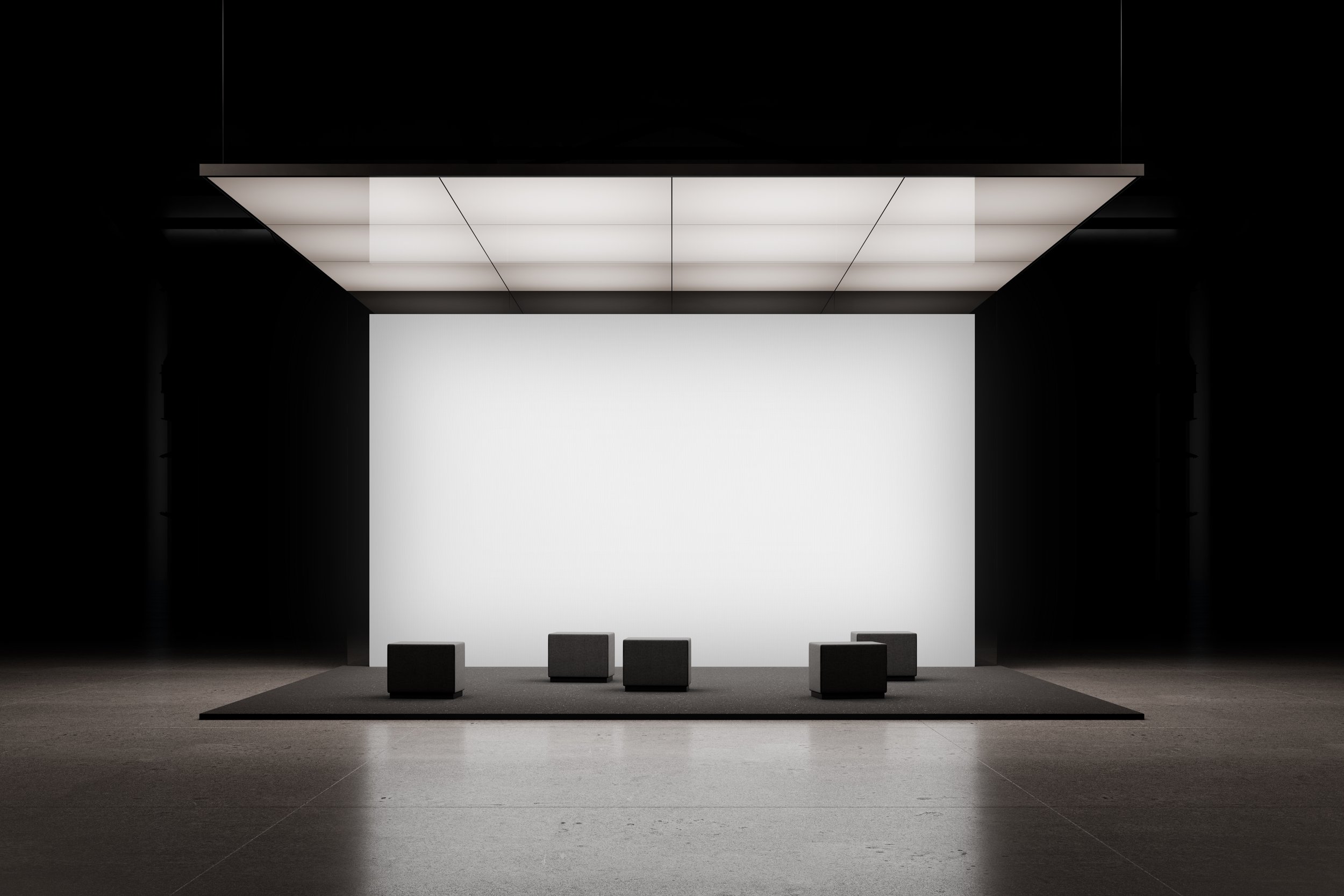 Exhibition stand mockup with five black upholstered seating cubes in front of an illuminated white backdrop