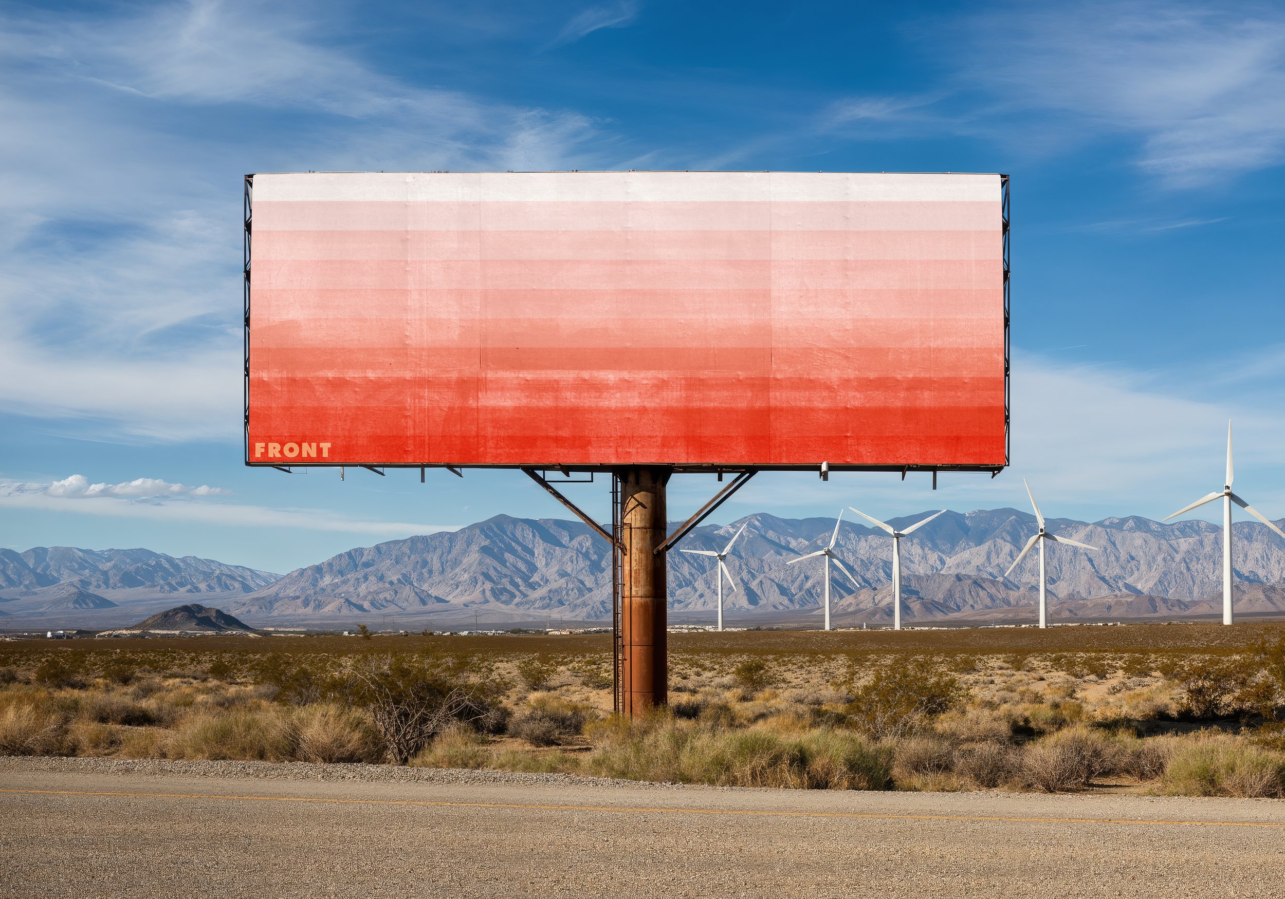 FRONT outdoor billboard mockup with red gradient design in a desert landscape with mountains and wind turbines.