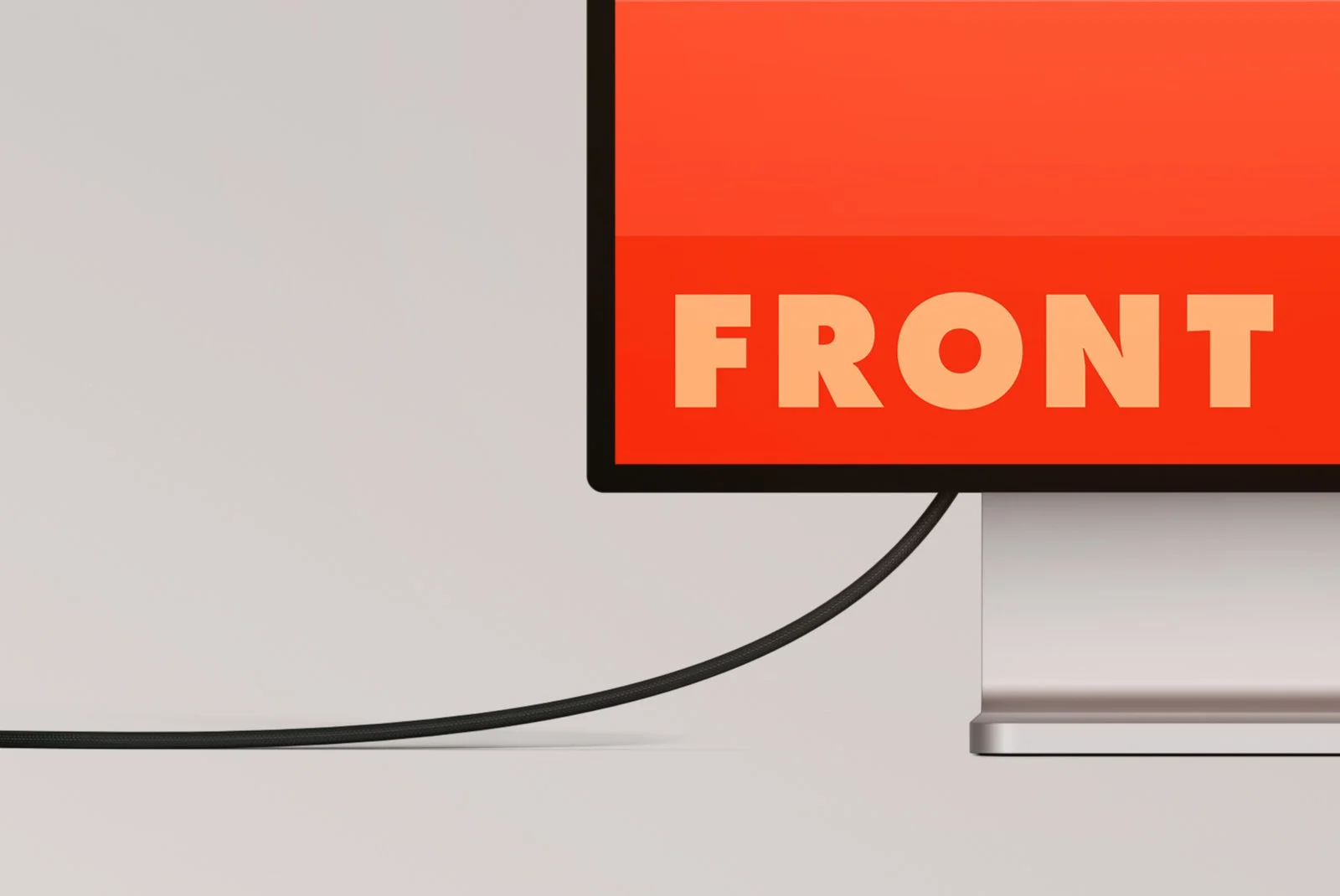 Close-up of cable and display edge showing ‘FRONT’ text on vibrant gradient