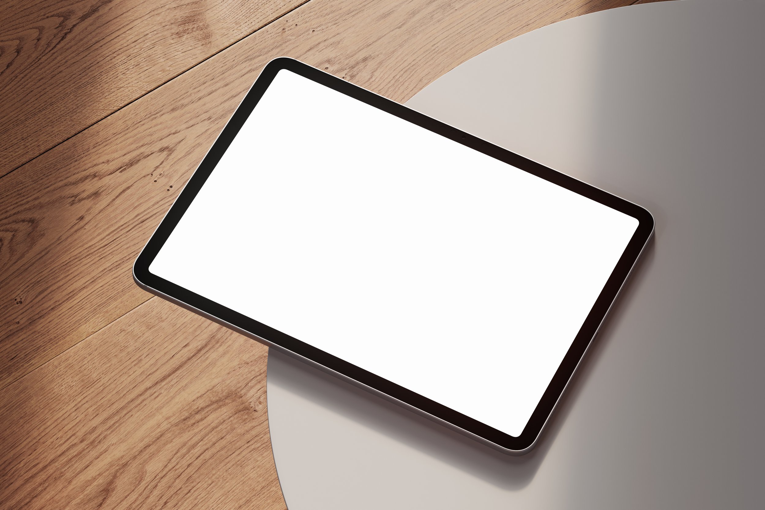 iPad Pro mockup on white table with wooden floor in background – FRONT Mockups