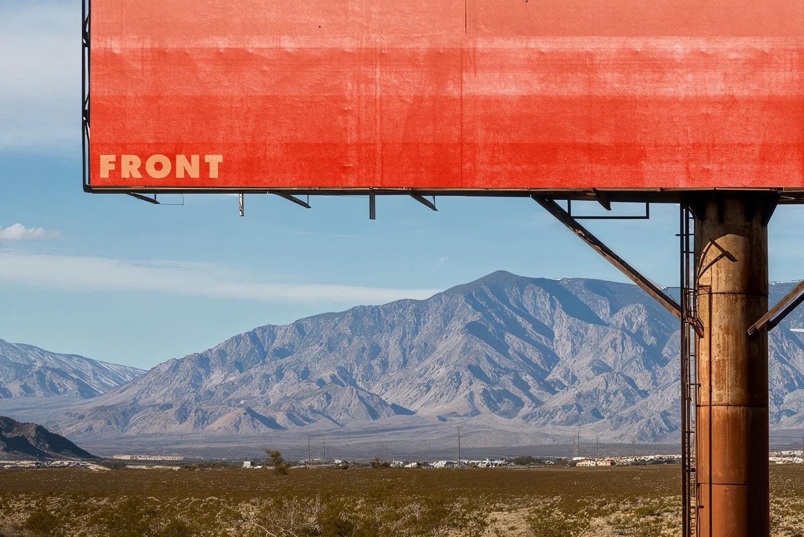 Close-up of FRONT billboard mockup showing red gradient design, rusted pole, and mountain landscape.