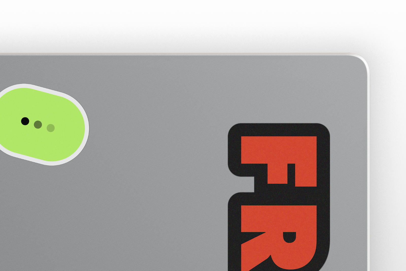 Close-up of MacBook sticker mockup with colorful decals