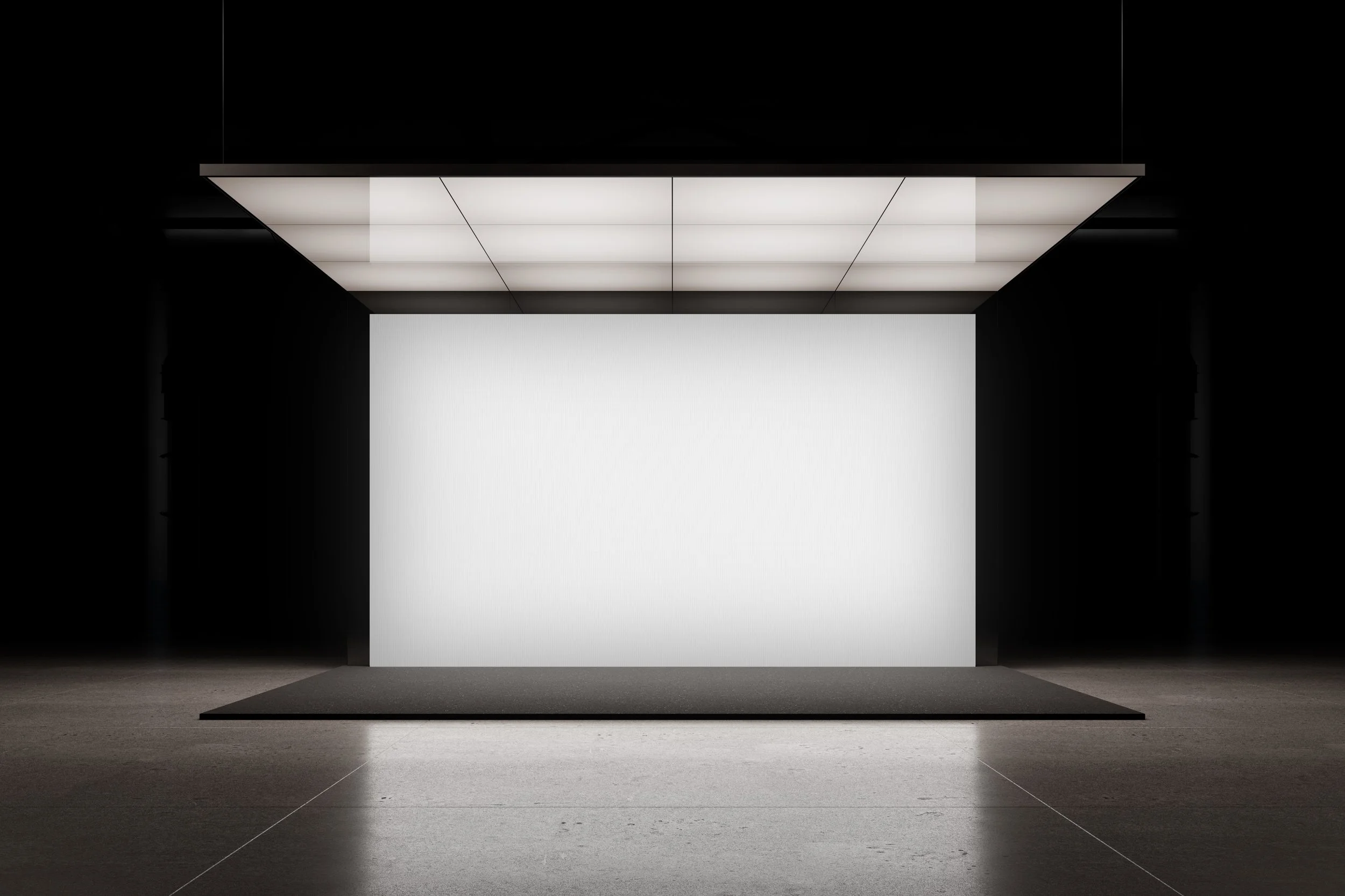 Minimal exhibition stand mockup with illuminated white backdrop and no furniture