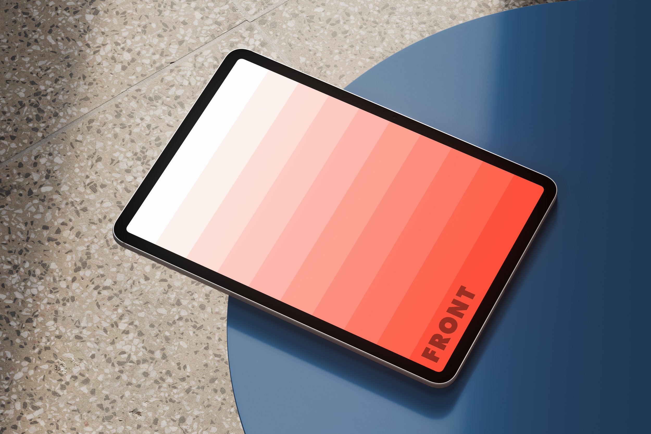 iPad Pro mockup on blue table with terrazzo floor in background – FRONT Mockups