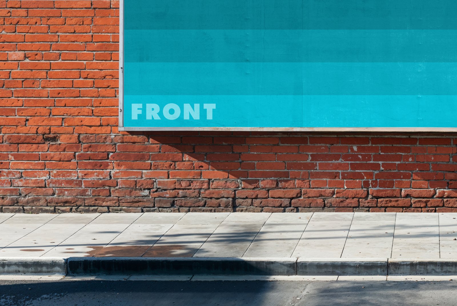 Close-up of billboard mockup with blue display and sidewalk – FRONT Mockups
