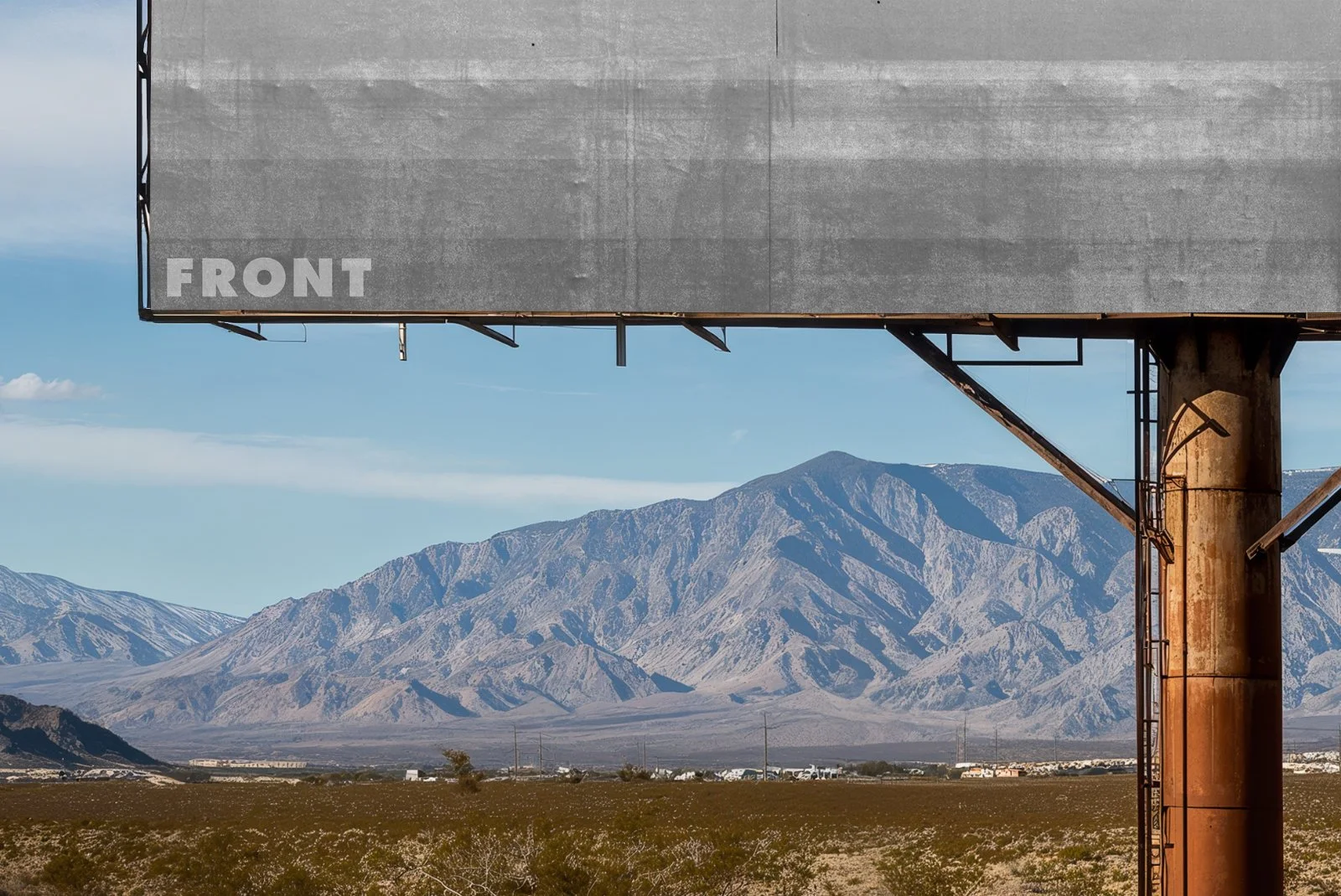 Close-up of FRONT blank billboard mockup with metal pole and desert mountains in the background.
