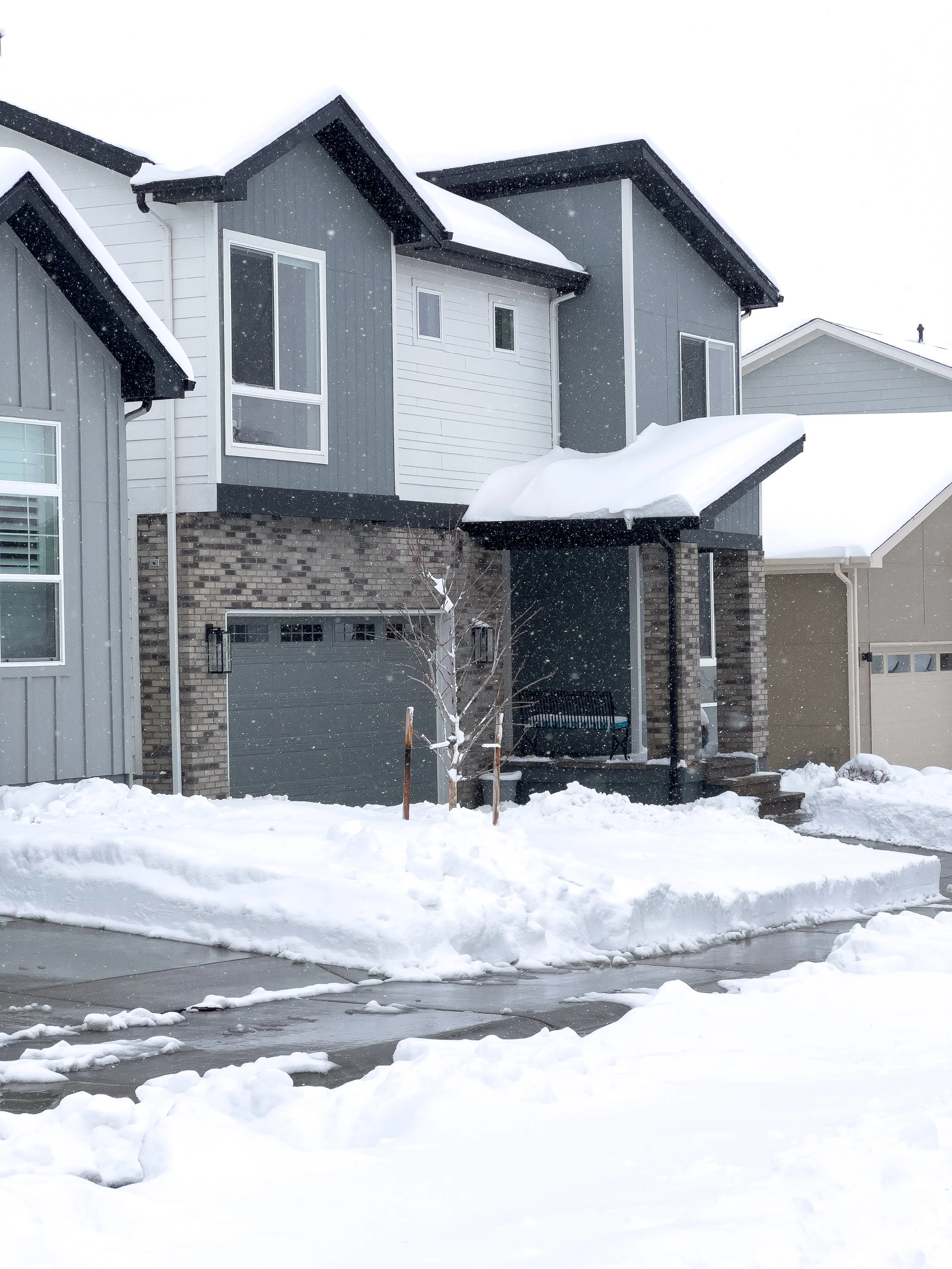 Two-story Minnesota home covered in fresh snow — the type of property protected by the Compass Winter Paradise Program while homeowners travel.