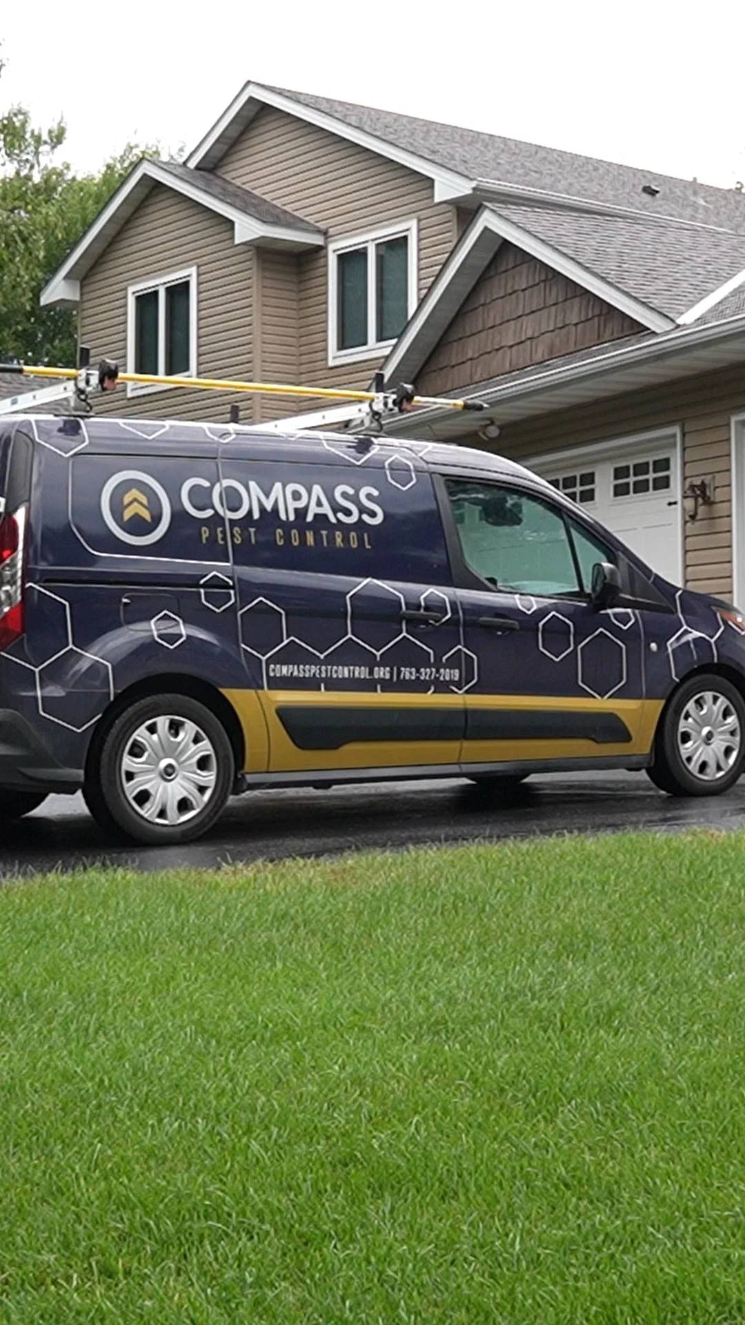Compass Pest Control service van parked in the driveway of a Central Minnesota home, ready for a residential rodent inspection.