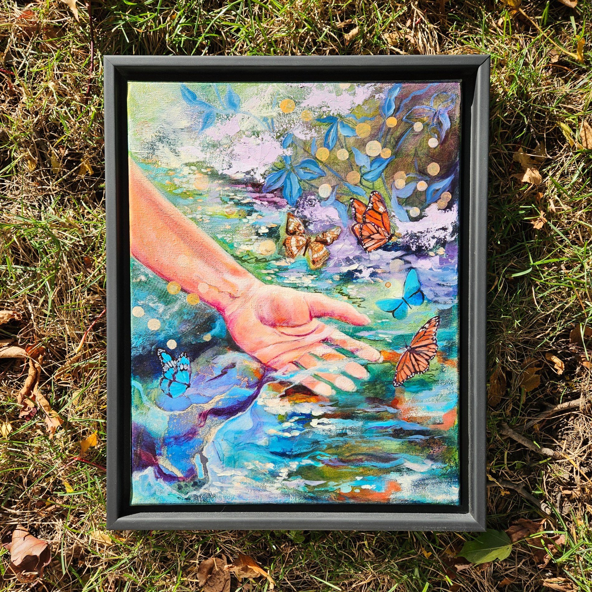 The hand becomes part of the stream, the butterflies linger like whispers of light, and for a heartbeat, everything feels connected.

'One with All' is a small oil and mixed media painting from my Touch of Whimsy collection. It captures the serenity 