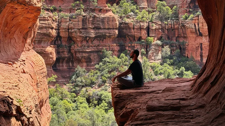 Meditating at the mouth of a red rock cave in Sedona, Arizona