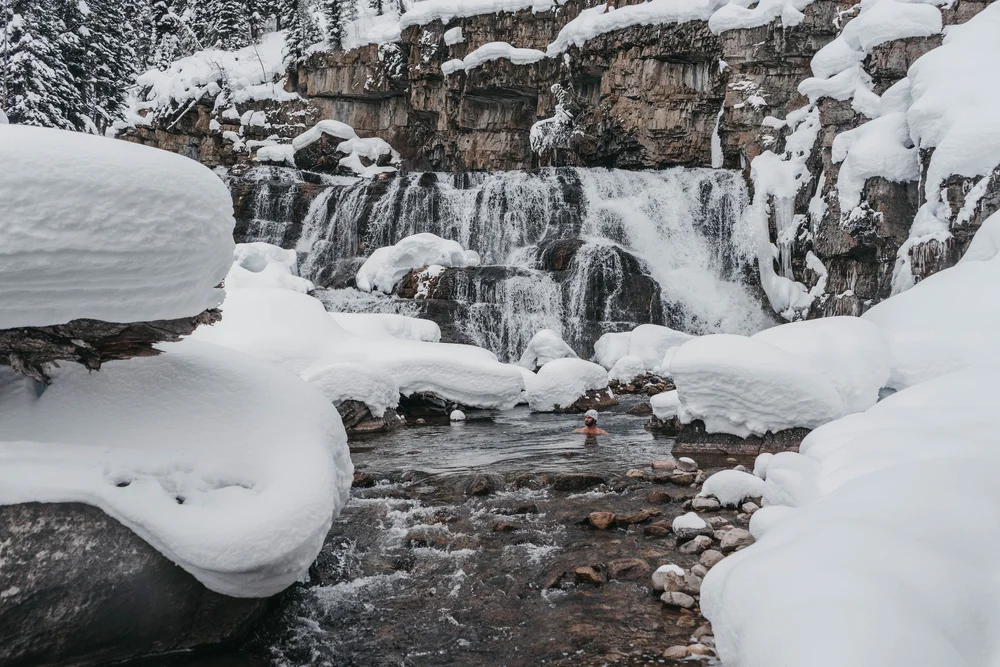 A snowy mountain stream running through rocks