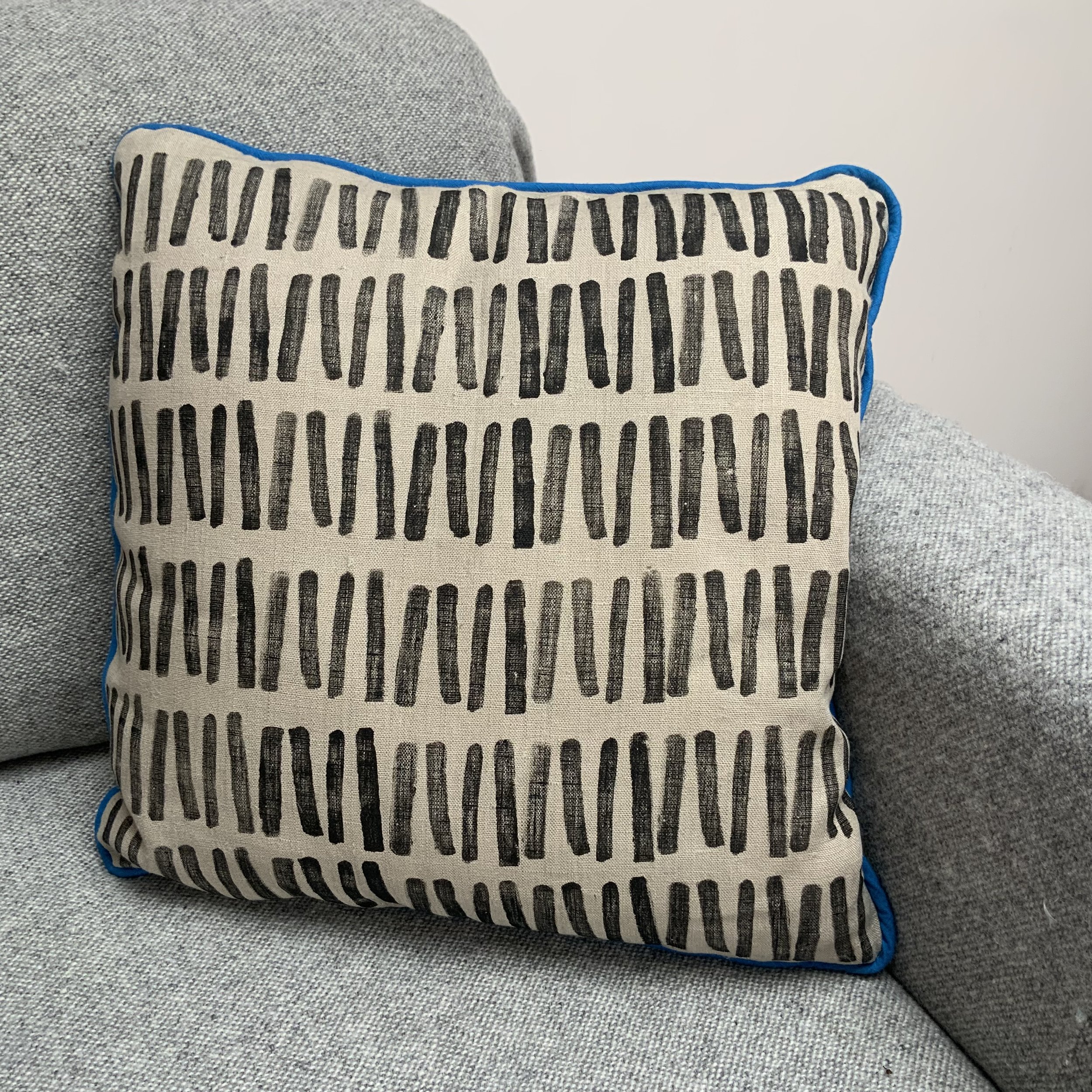 Sustainable and uniue hand-printed cushions in Devon with potatoes by Susie Honnor. Cushion on sofa