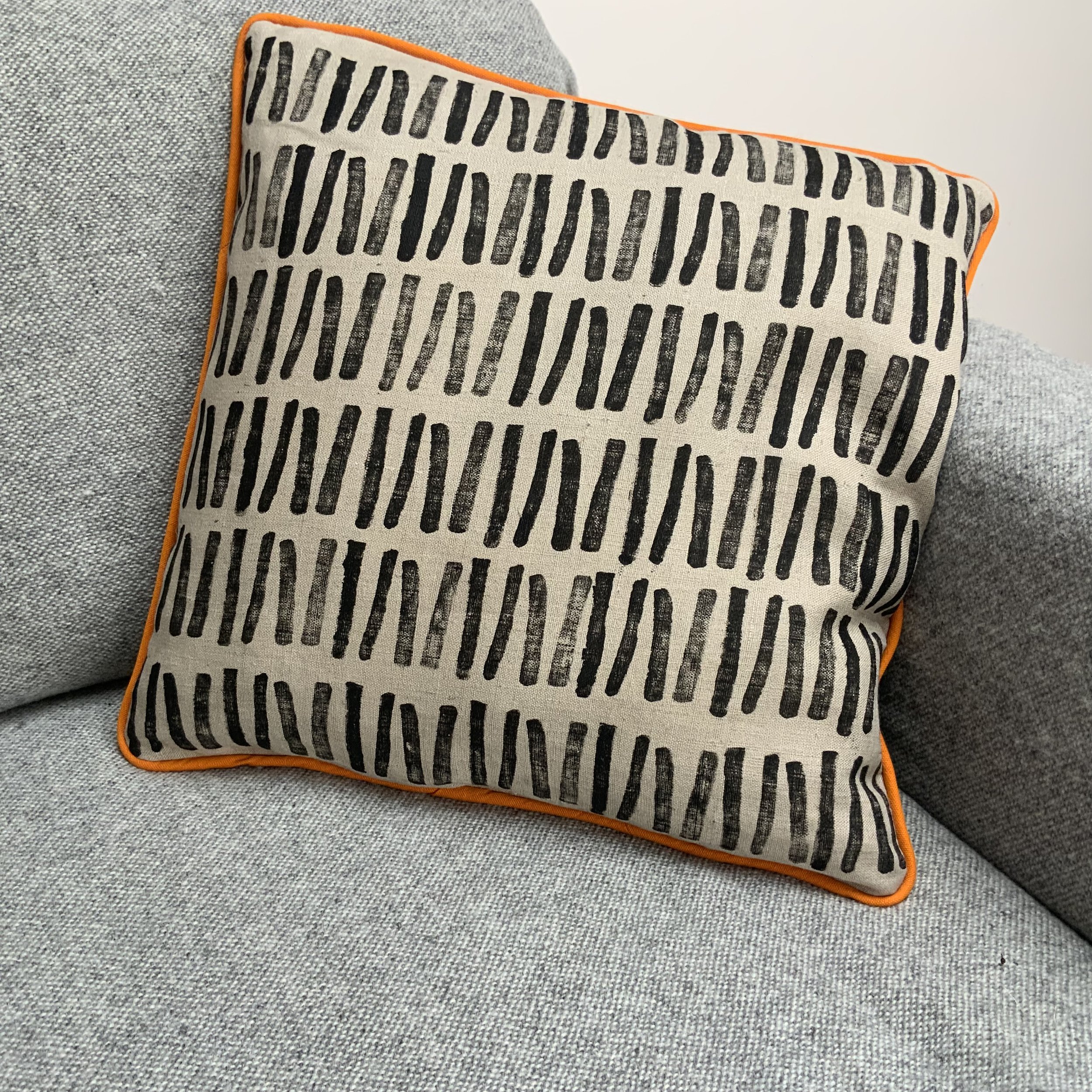 Sustainable and uniue hand-printed cushions in Devon with potatoes by Susie Honnor. Cushion on sofa.