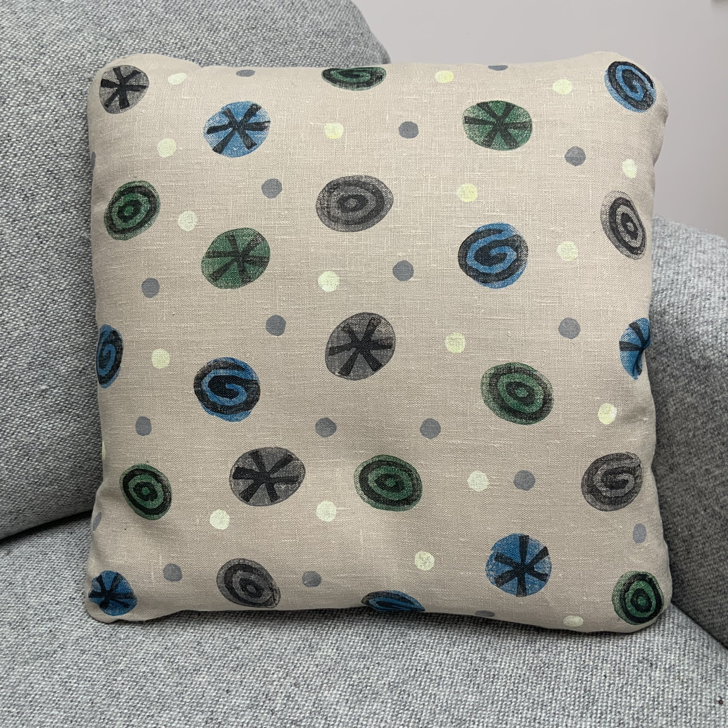 Sustainable and uniue hand-printed cushions in Devon with potatoes by Susie Honnor. Cushion on sofa.
