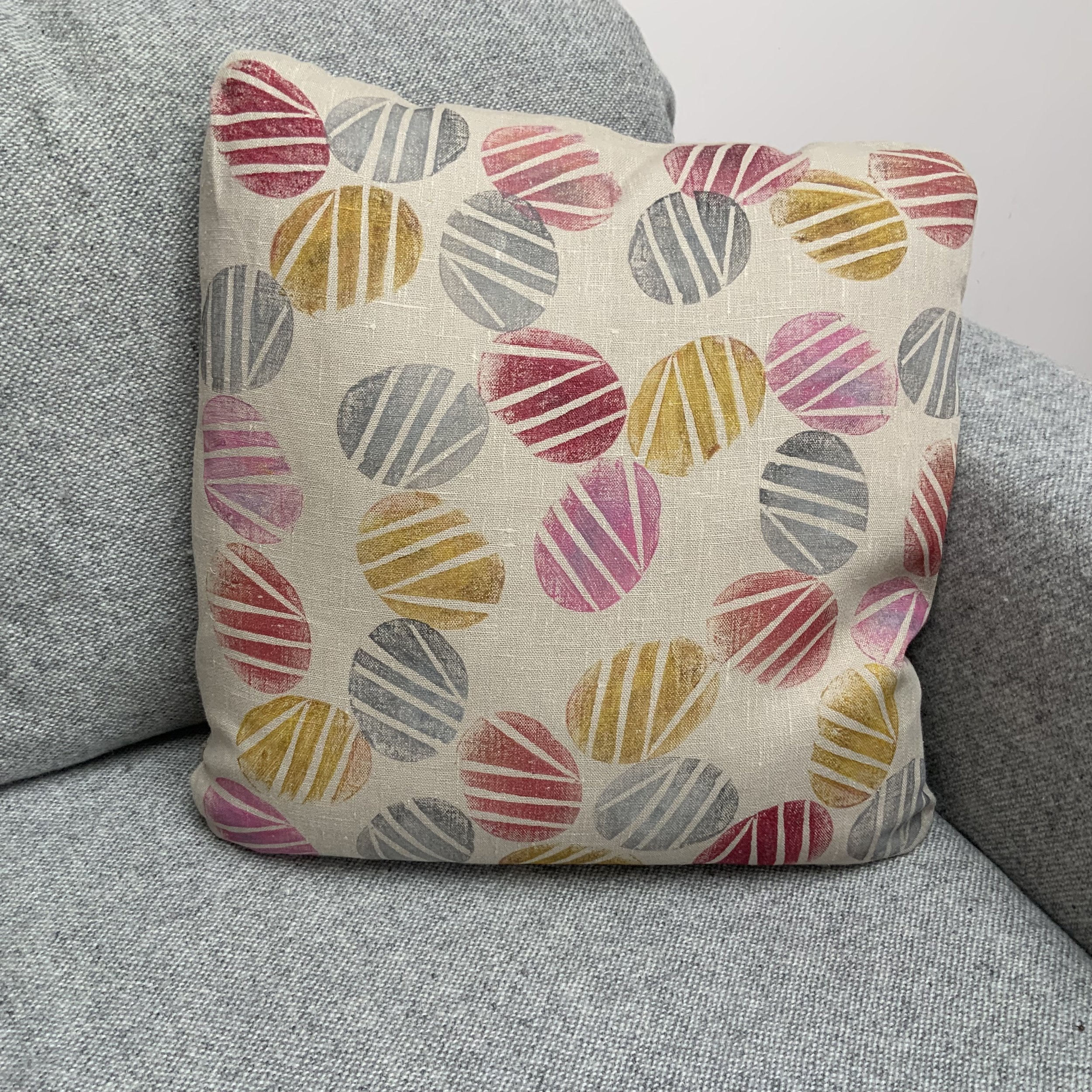 Sustainable and uniue hand-printed cushions in Devon with potatoes by Susie Honnor. Cushionj on sofa.