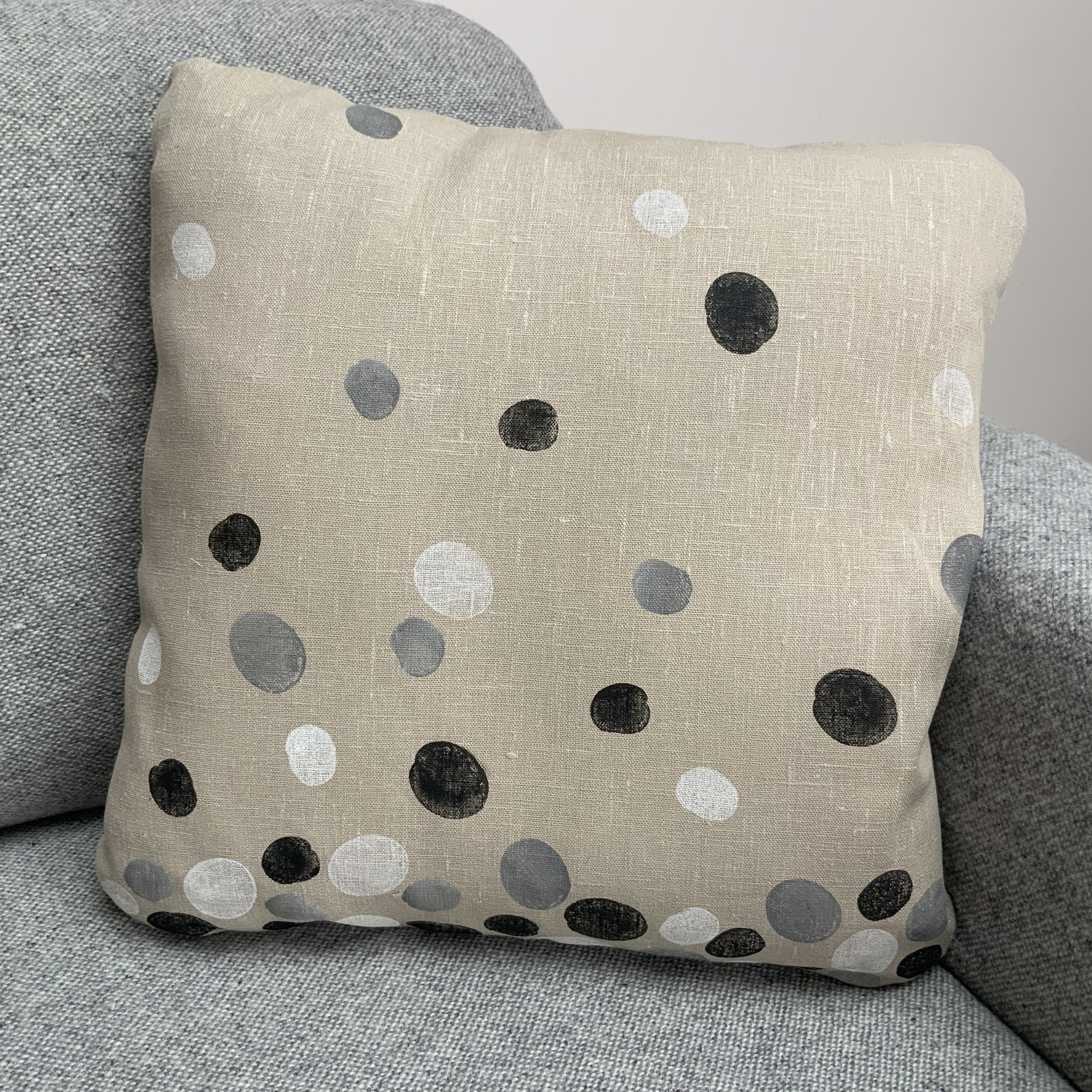 Sustainable and uniue hand-printed cushions in Devon with potatoes by Susie Honnor. Cushion on sofa.