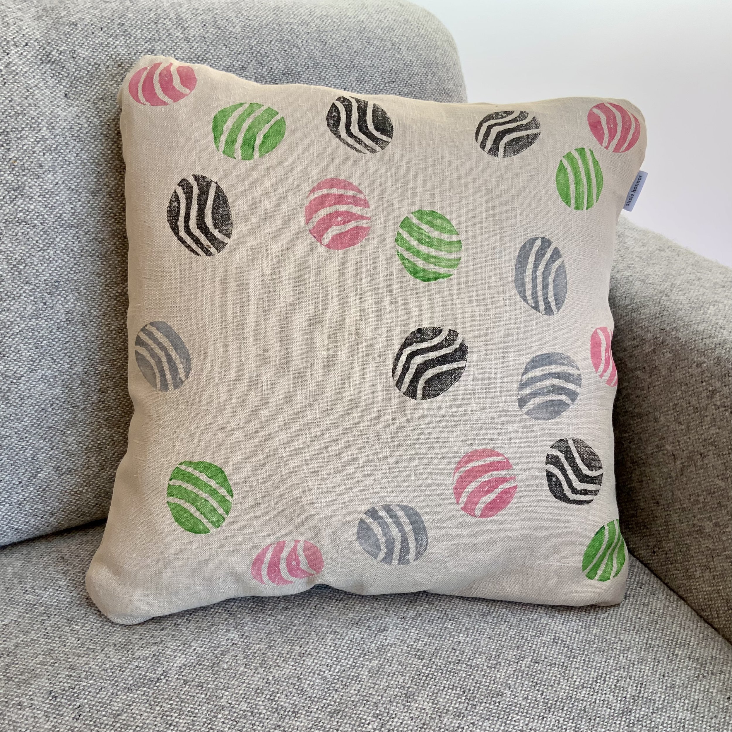 Sustainable and uniue hand-printed cushions in Devon with potatoes by Susie Honnor. Cusion on sofa