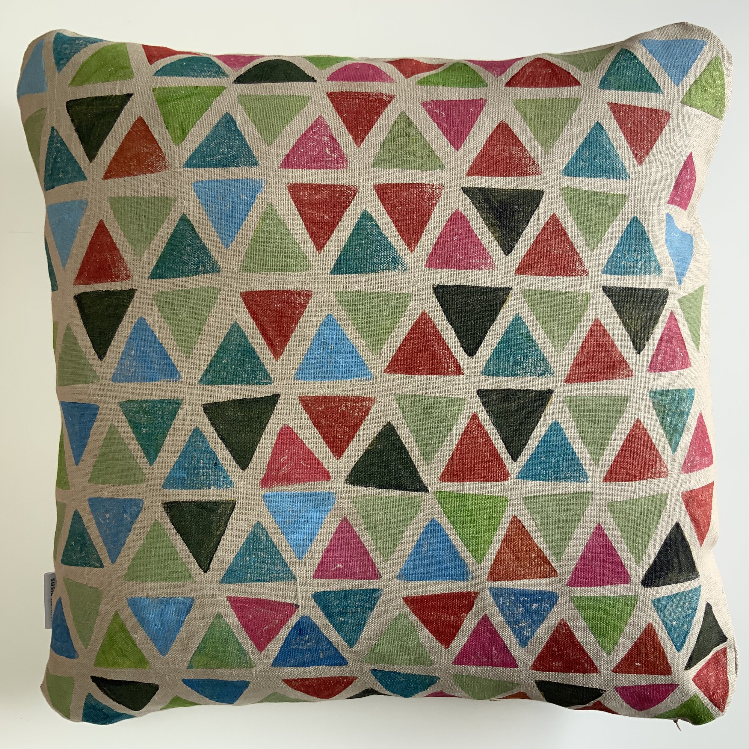 Potato printed cushion by Susie Honnor in Devon on 100% natural linen. Triangles in multicolours tumbling in space. Back side