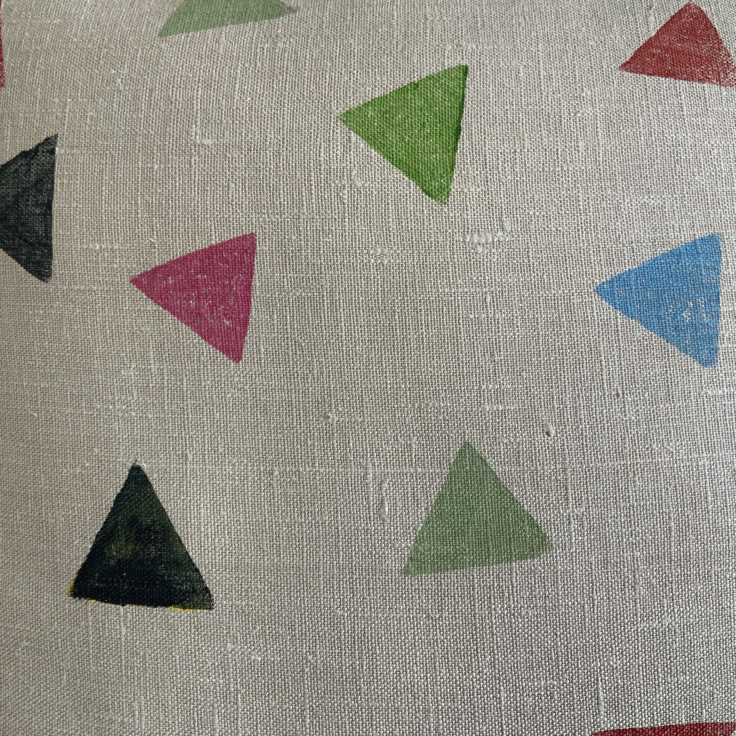 Potato printed cushion by Susie Honnor in Devon on 100% natural linen. Triangles in multicolours tumbling in space. Back side detail.
