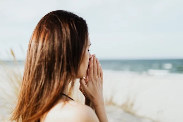 A woman feeling calm at the beach