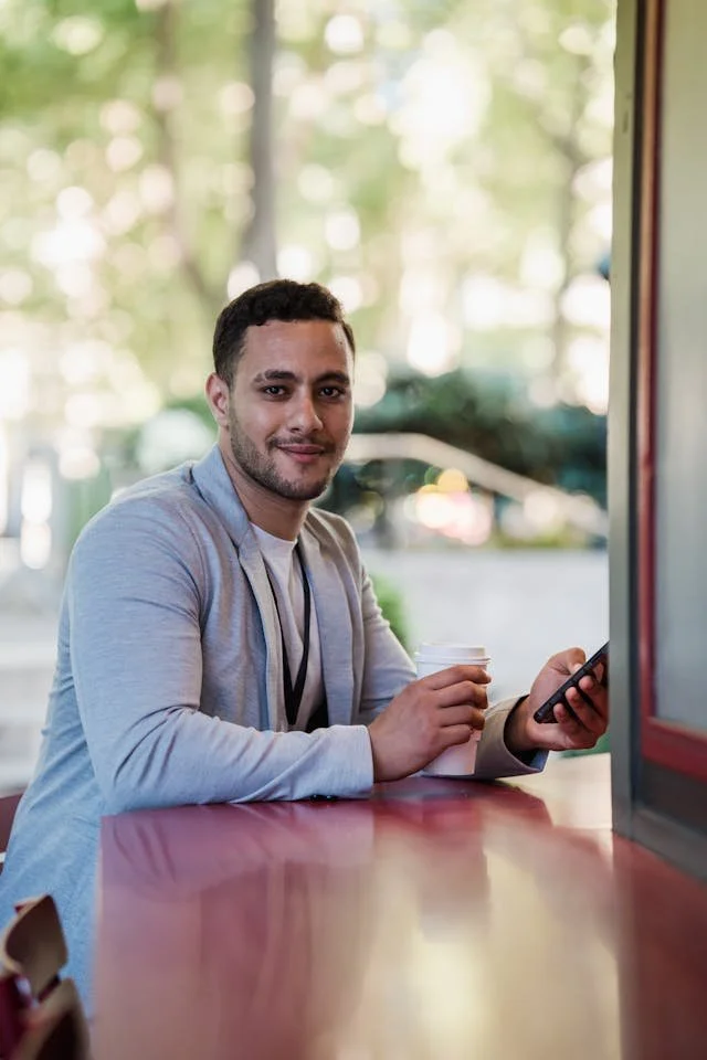 A man having a coffee and smiling