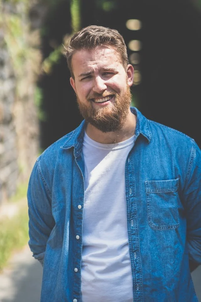 a man with a beard smiling