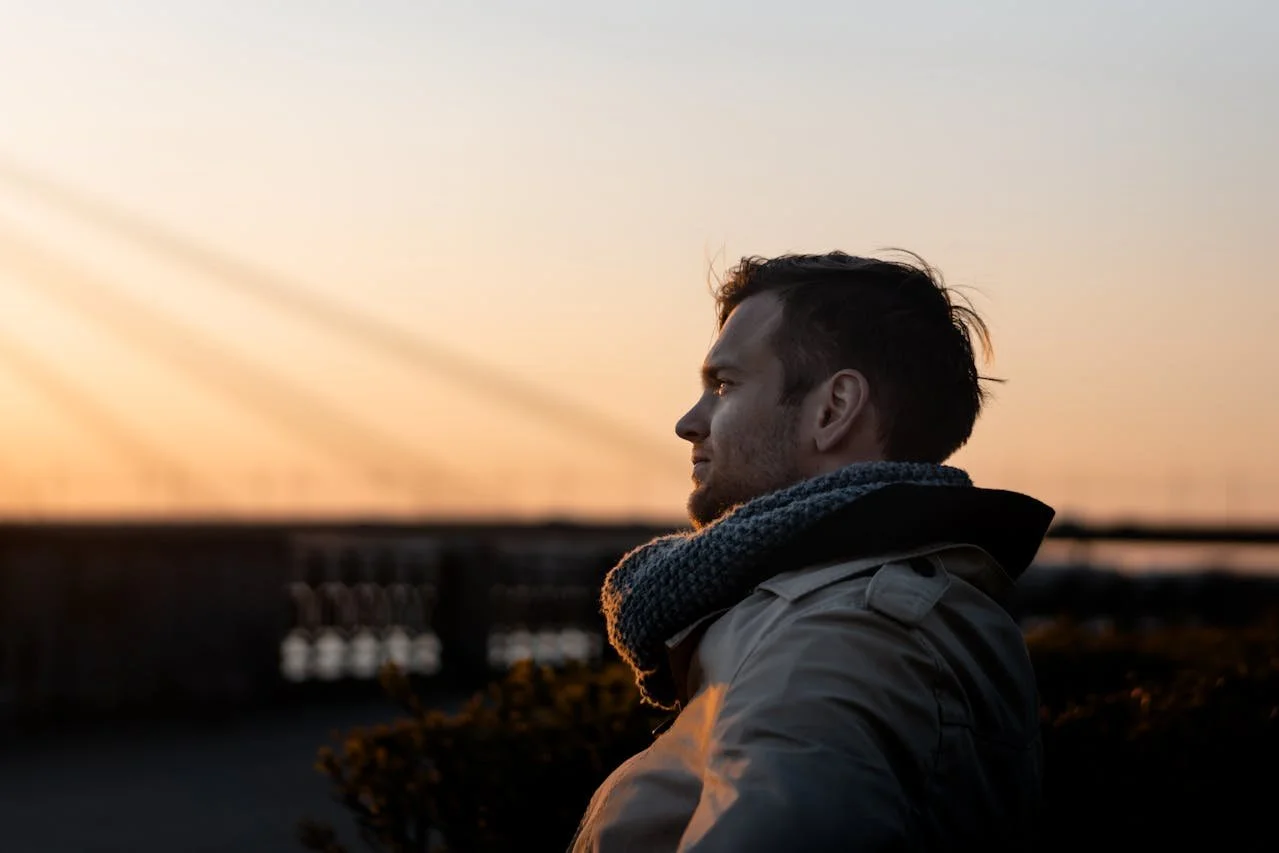 man-wearing-gray-coat-during-golden-hour