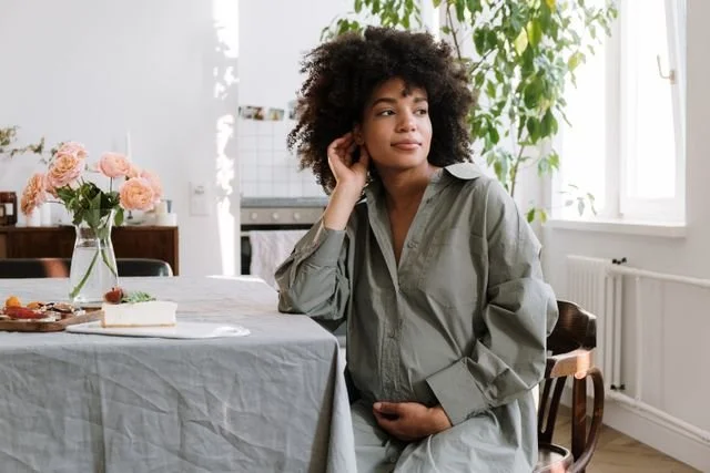A pregnant woman sitting at a table