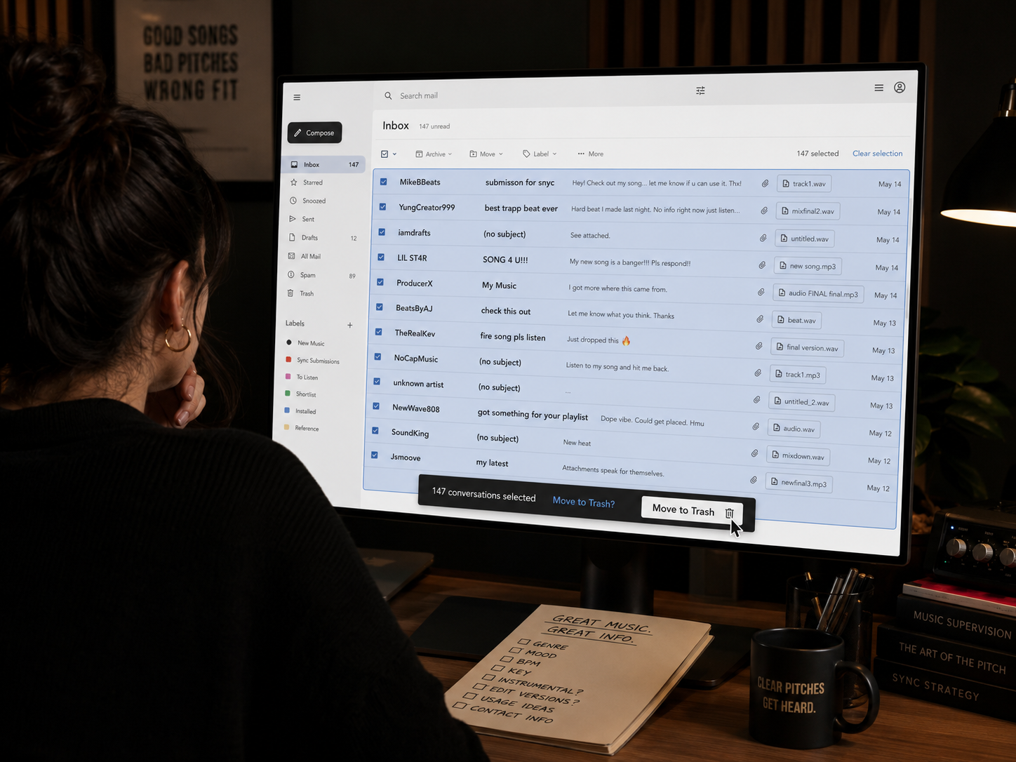 A music supervisor is checking their email and clearing out  a bunch of poorly formatted submissions for a music library they manage.