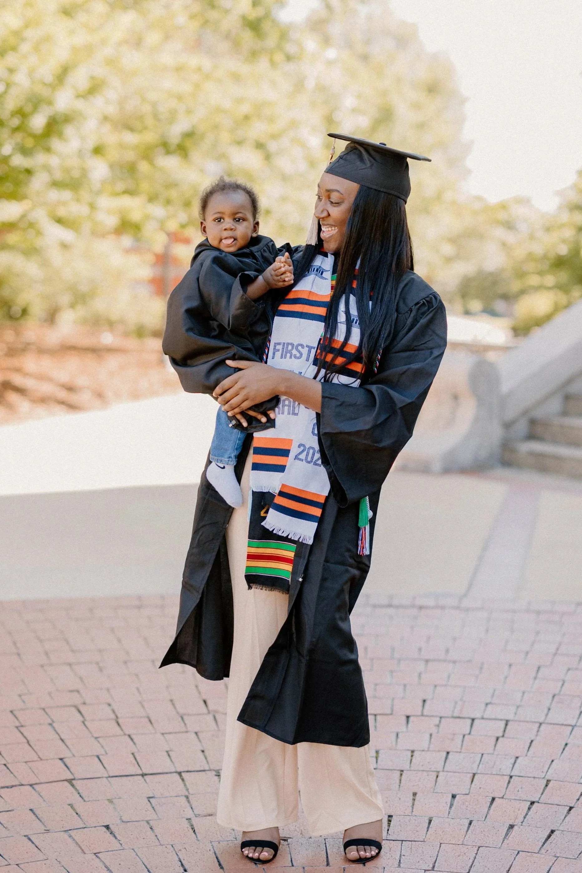 Veronica and her baby as a first generation graduate and a Student-Mom