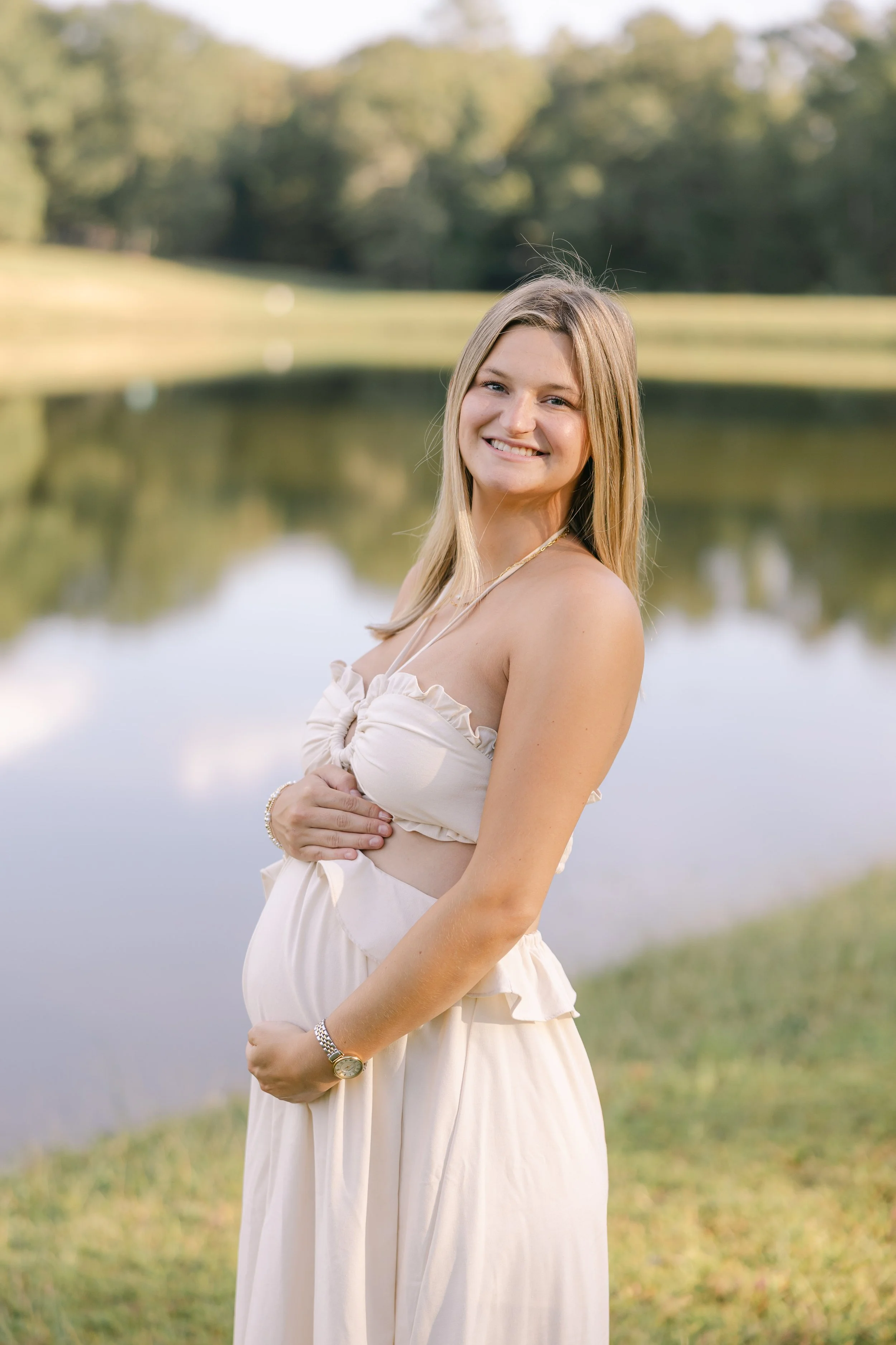 Pregnant Student-Mom holding her baby bump in maternity photos