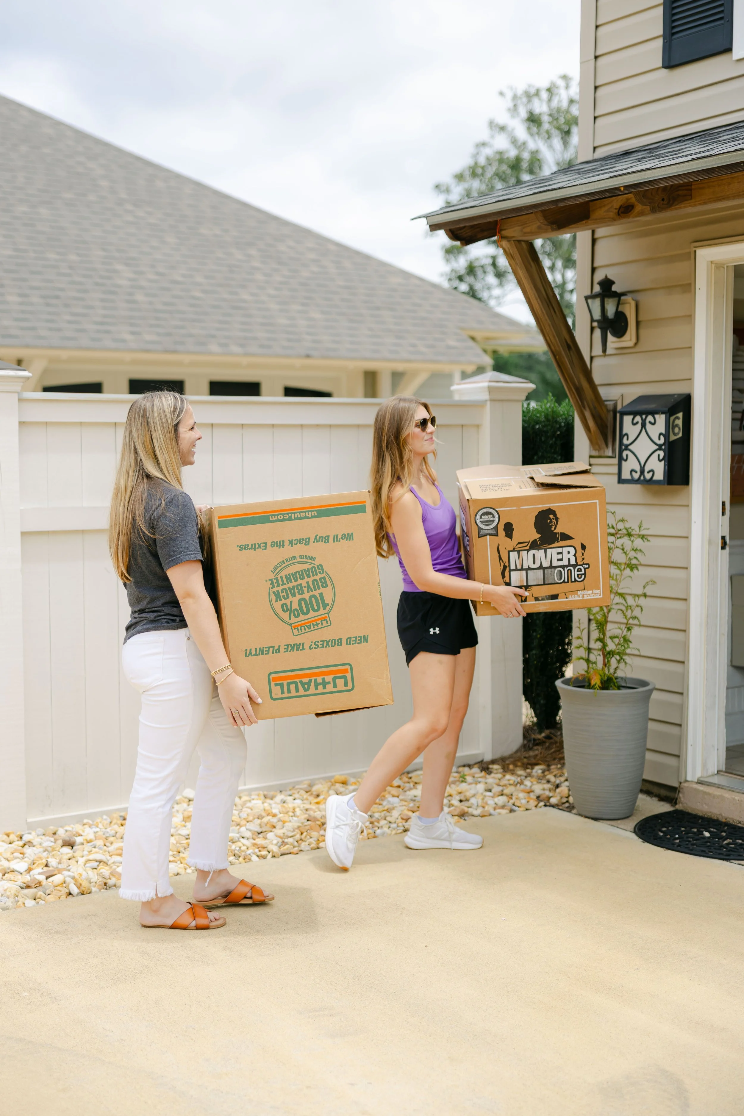 Volunteers moving boxes on the Baby Steps property
