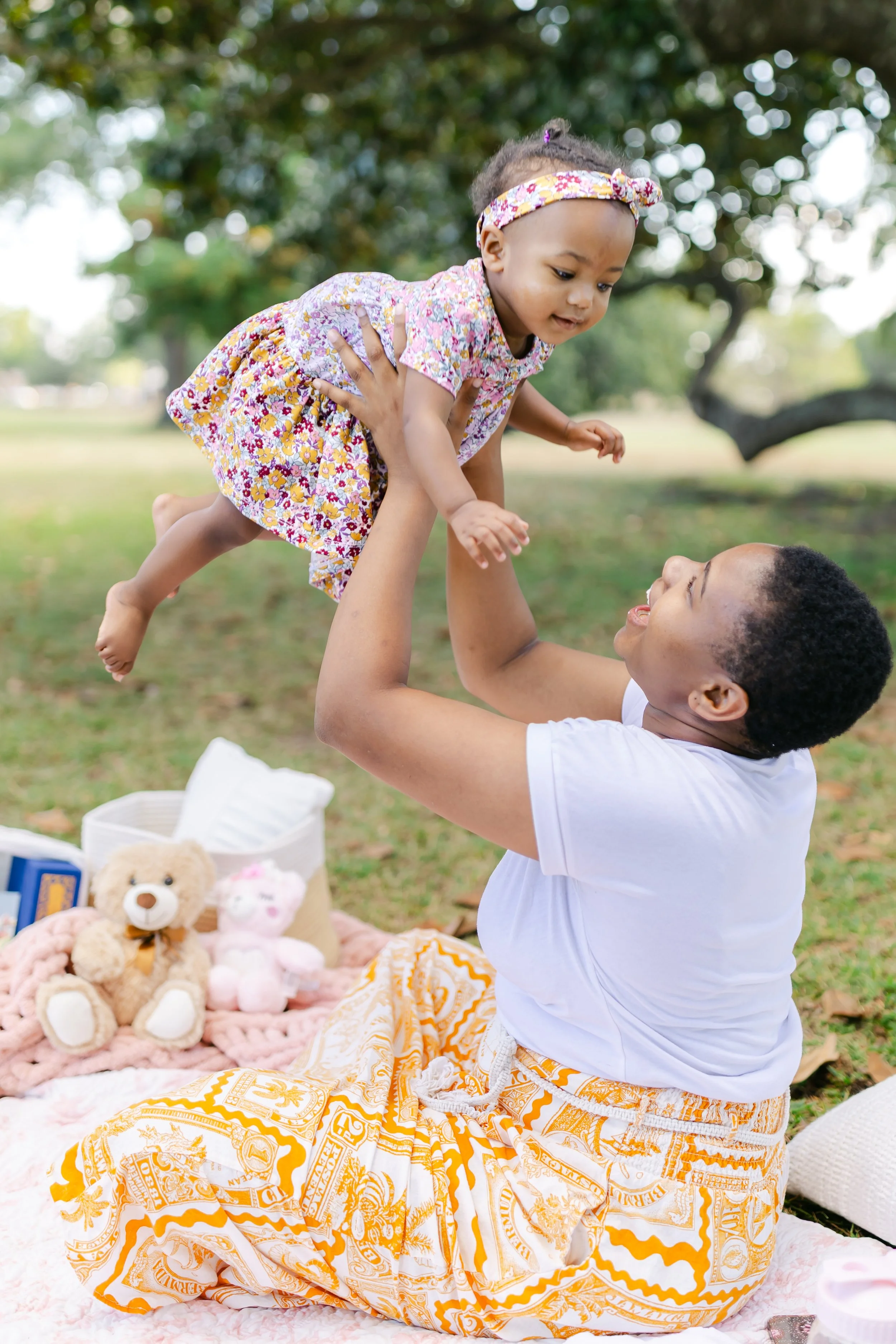 Student-Mom playing with her baby on campus