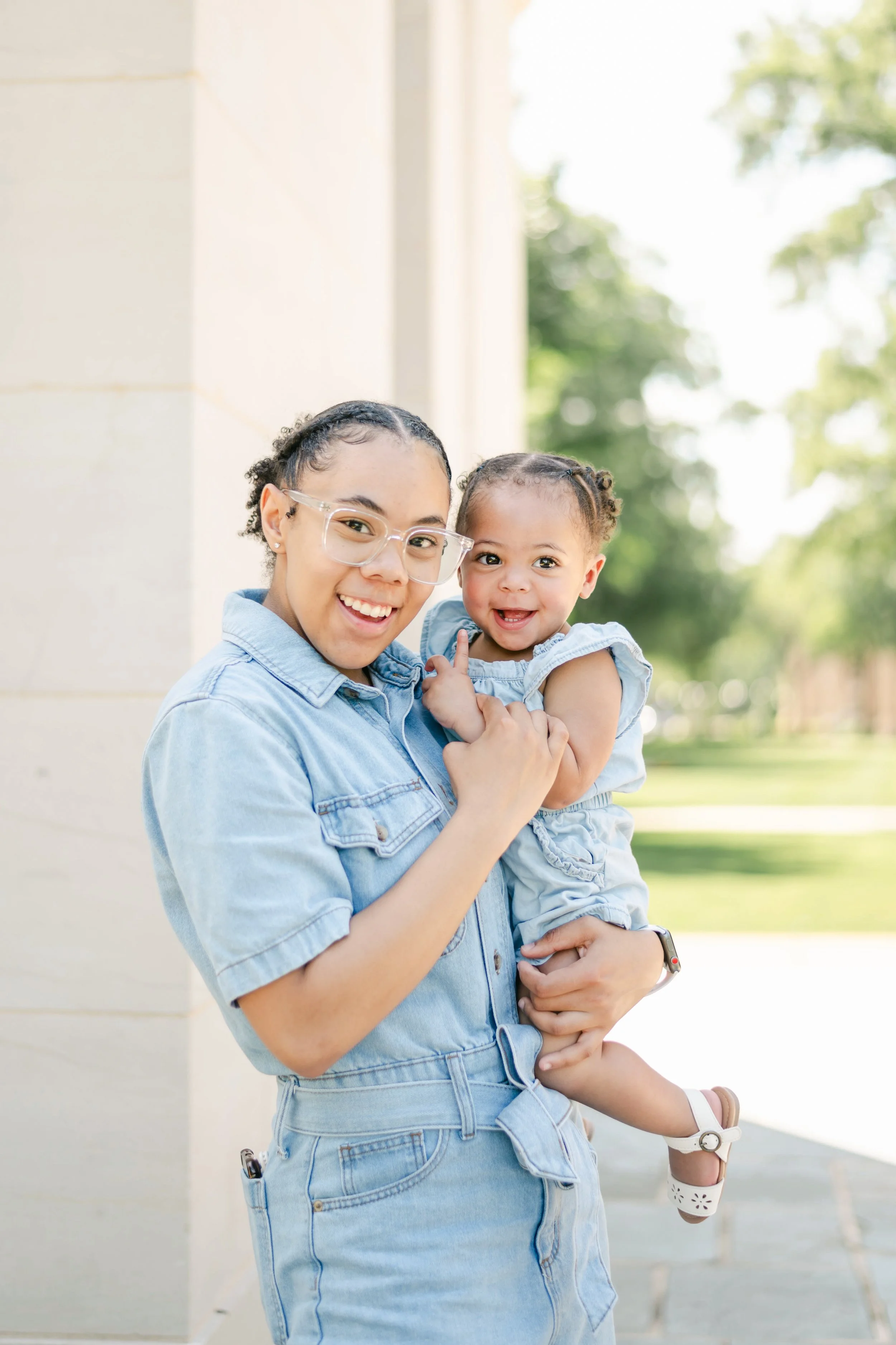 student mom and her baby in front of denny chimes on alabama's campus