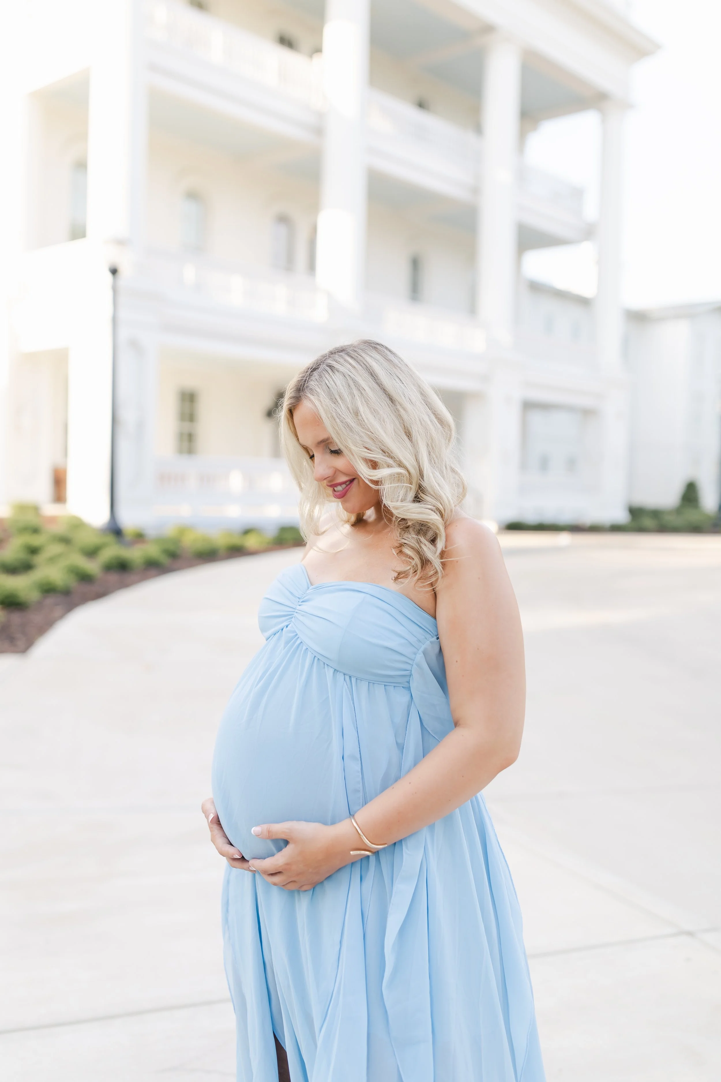 pregnant Student-mom holding her baby bump on Alabama's campus