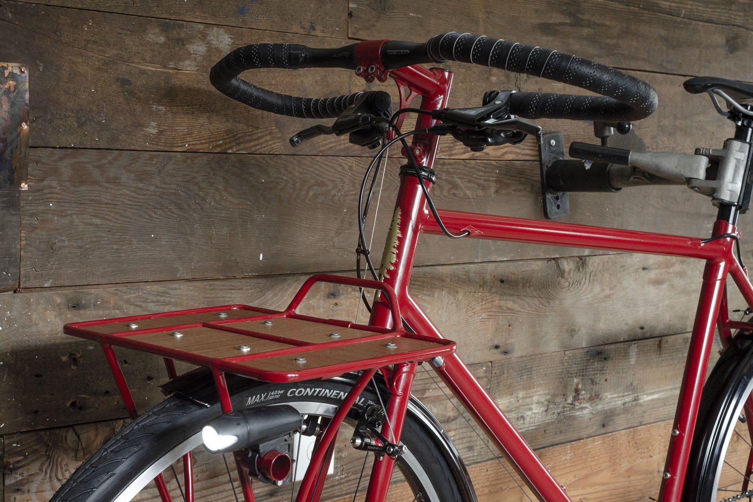 Custom platform rack with wood slat detail on a handmade touring bicycle.