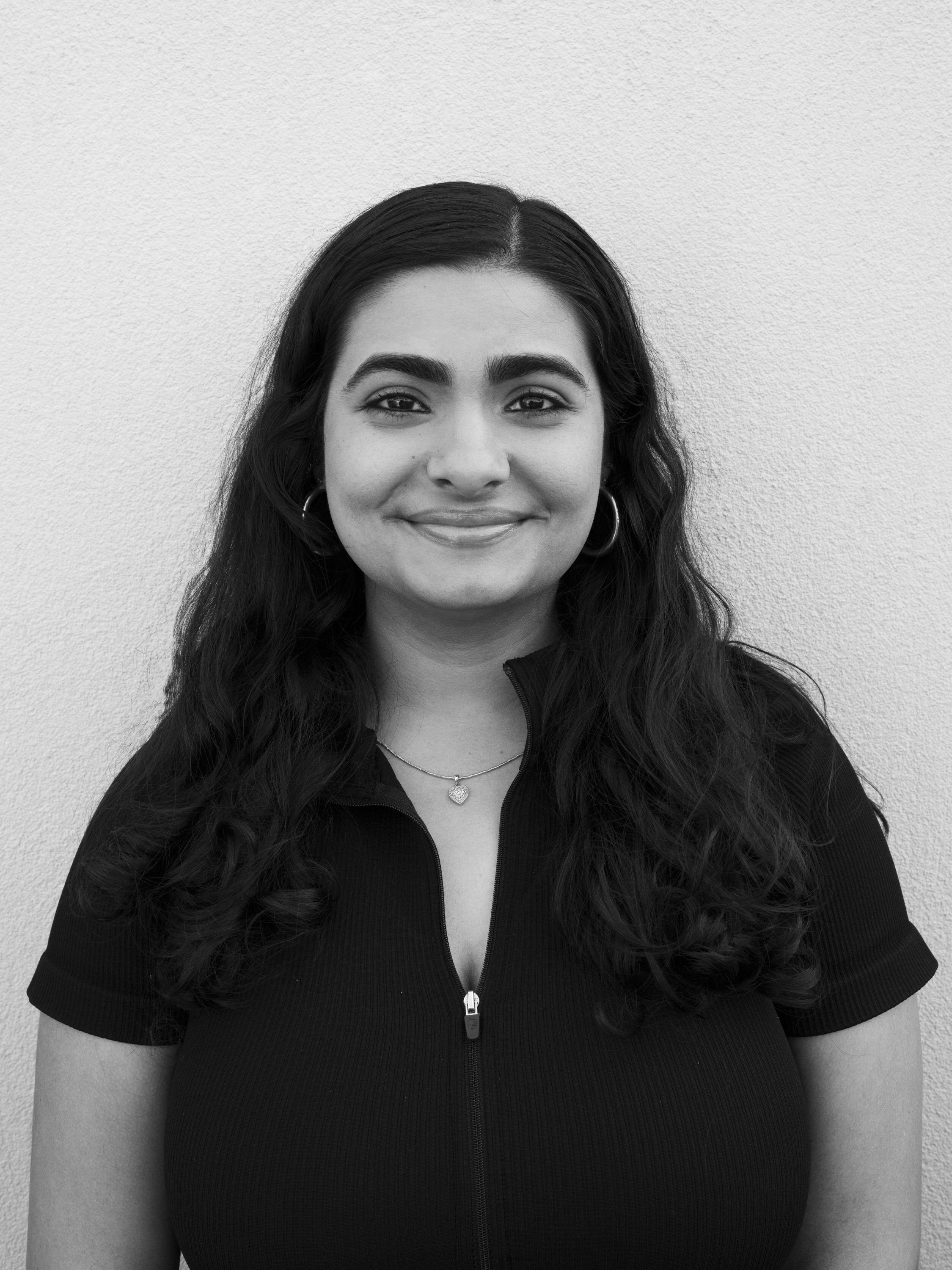 A black and white headshot of Divya Gangwani