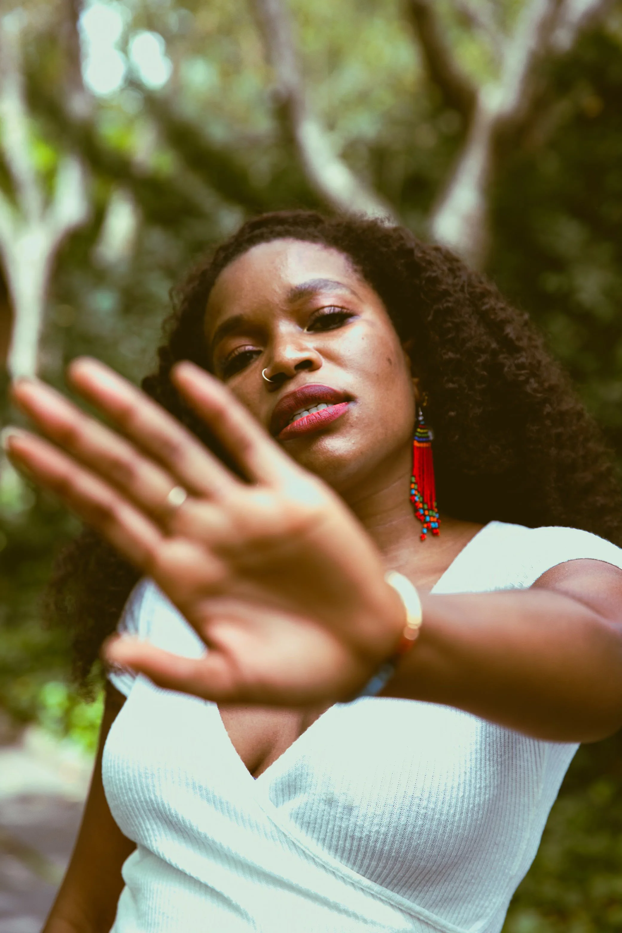Photo of I.S. Jones holding the palm of her hand between her and the camera